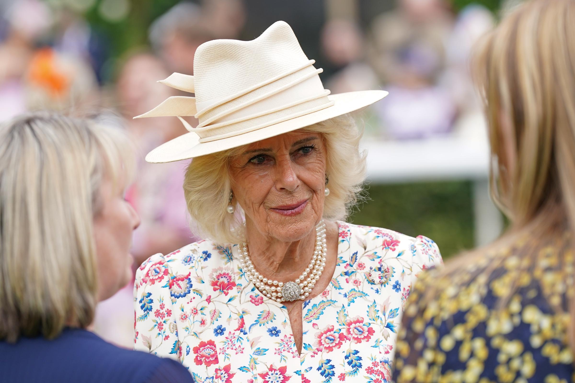 Queen Camilla meets representatives from local charities supported by the York racecourse, during the Ebor Festival in England on August 21, 2025 | Source: Getty Images