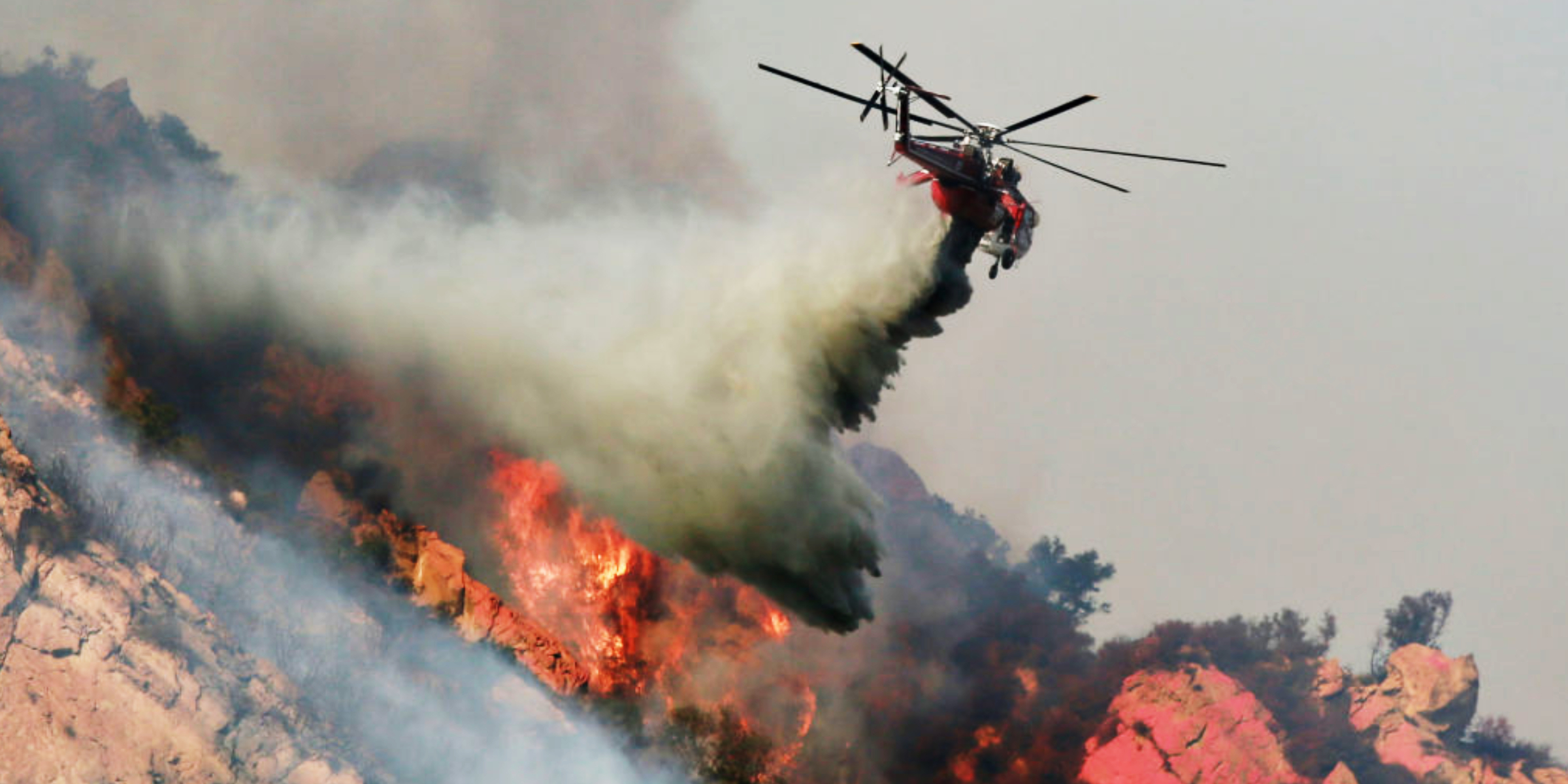 A helicopter putting out fires | Source: Getty Images