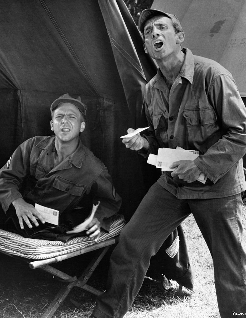 William Christopher and Christopher Dark receive mail from home in a scene from the film "The Private Navy of Sgt. O'Farrell," 1968 | Photo: Getty Images