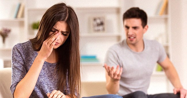 A man and a woman having an argument in their living room | Photo: Shutterstock
