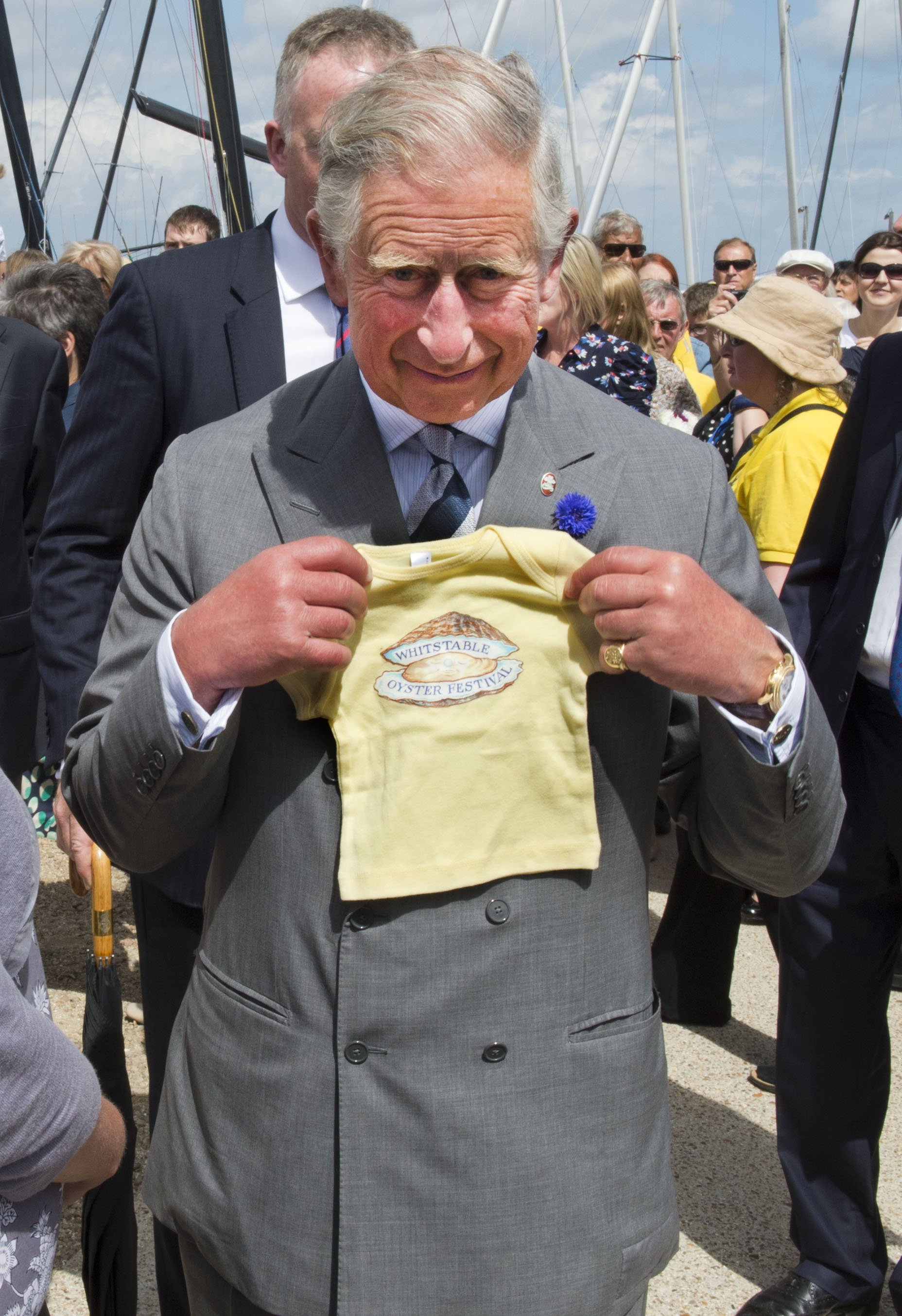 King Charles is seen with a present for his grandson Prince George of Cambridge during a visit to The Whitstable Oyster Festival on July 29, 2013, at Whitstable Harbour, Whitstable, Kent. | Source: Getty Images