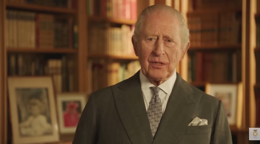 King Charles III is seen delivering his heartfelt tribute from the library at Balmoral Castle in a still taken from a video dated 21 April 2026, his expression composed yet reflective as he honours the life and legacy of Queen Elizabeth II against a backdrop of neatly arranged bookshelves and framed family photographs. | Source: YouTube/The Royal Family Channel
