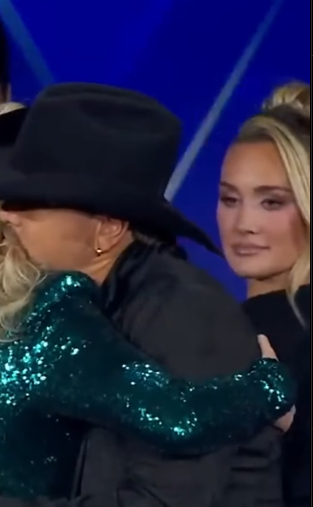 Brittany Aldean looks on as Erika Kirk and her husband Jason Aldean embrace during the 2025 Fox Nation Patriot Awards | Source: Instagram/the.independent