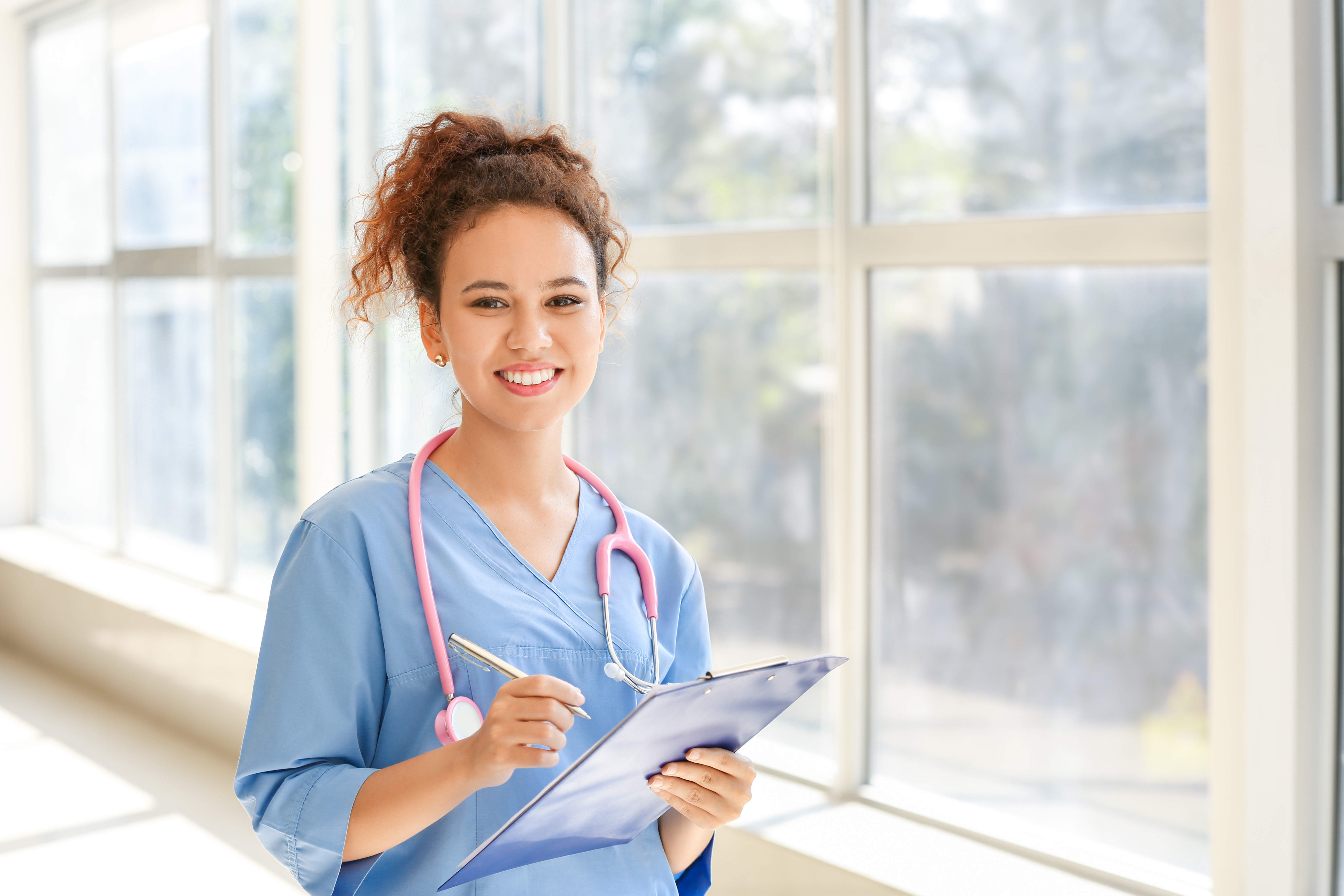 A young female nurse smiling | Source: Shutterstock