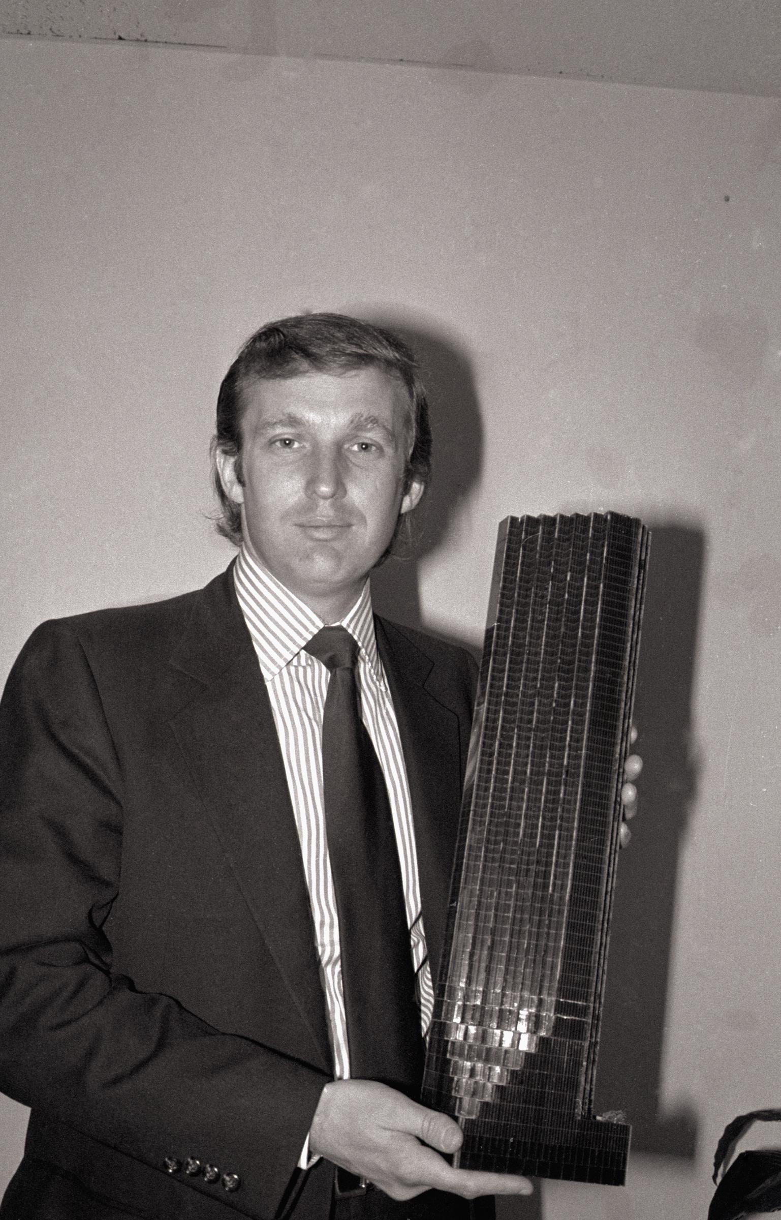 Donald Trump holding a model of the Trump Tower in Fifth Avenue in New York, on August 1, 1980 | Source: Getty Images