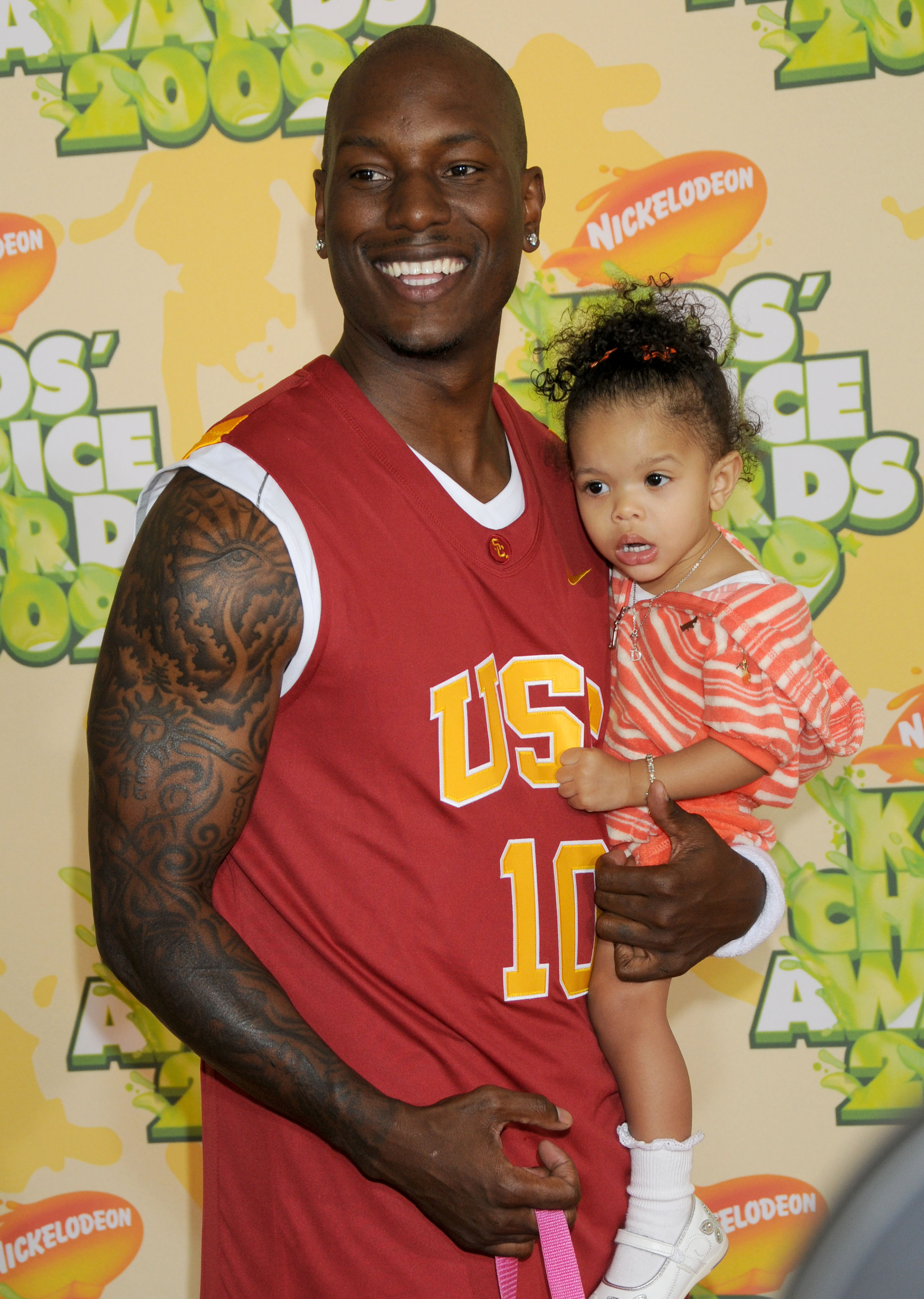Tyrese Gibson beamed proudly while holding a young Shayla Gibson close at the colorful Nickelodeon event. Dressed in a bold USC jersey, the singer looked every bit like a doting dad as his daughter curiously took in the crowd around her.