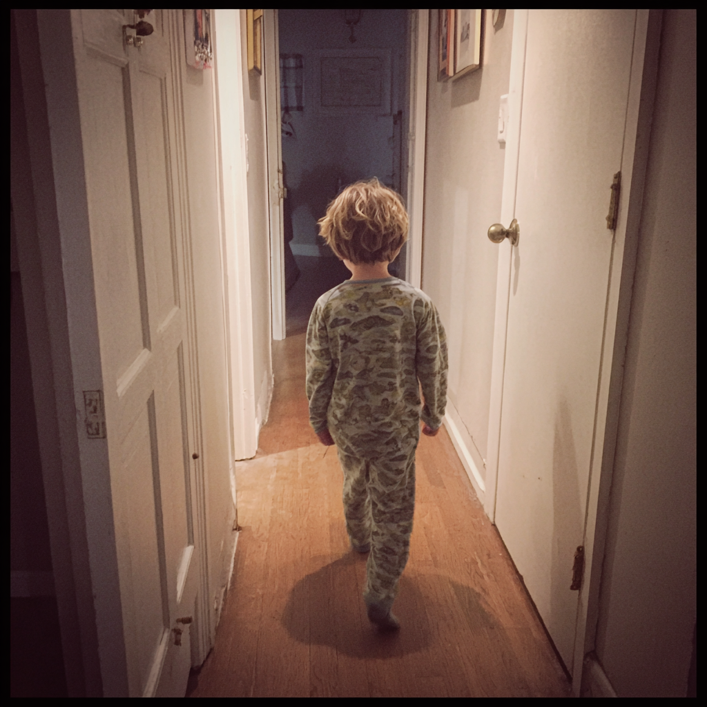 A little boy walking down a hallway | Source: Midjourney