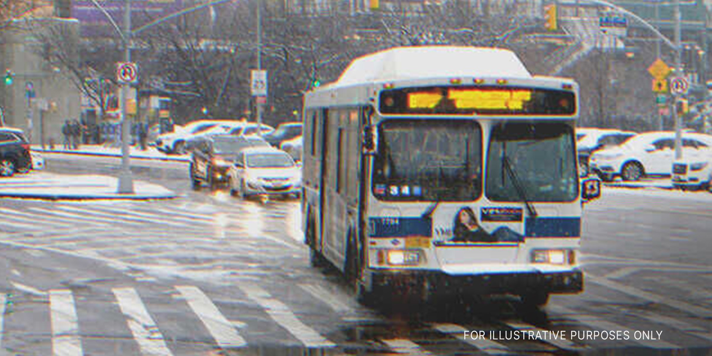 A bus drives across a crosswalk while it's raining | Source: Shutterstock