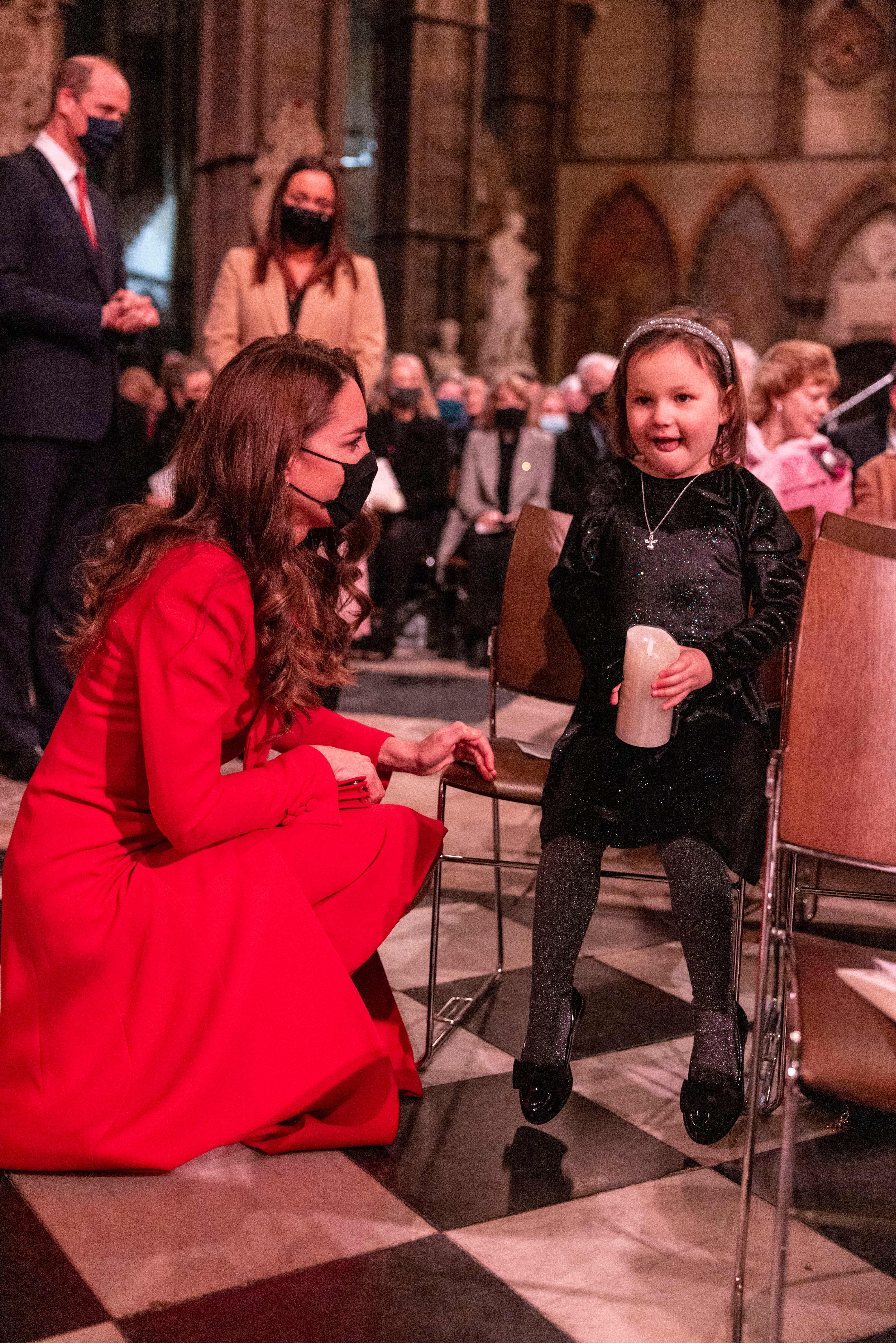 Catherine, Duchess of Cambridge (L) chats to 6-year-old Mila Sneddon, during the Together At Christmas community carol service at Westminster Abbey in London on December 8, 2021 | Source: Getty Images