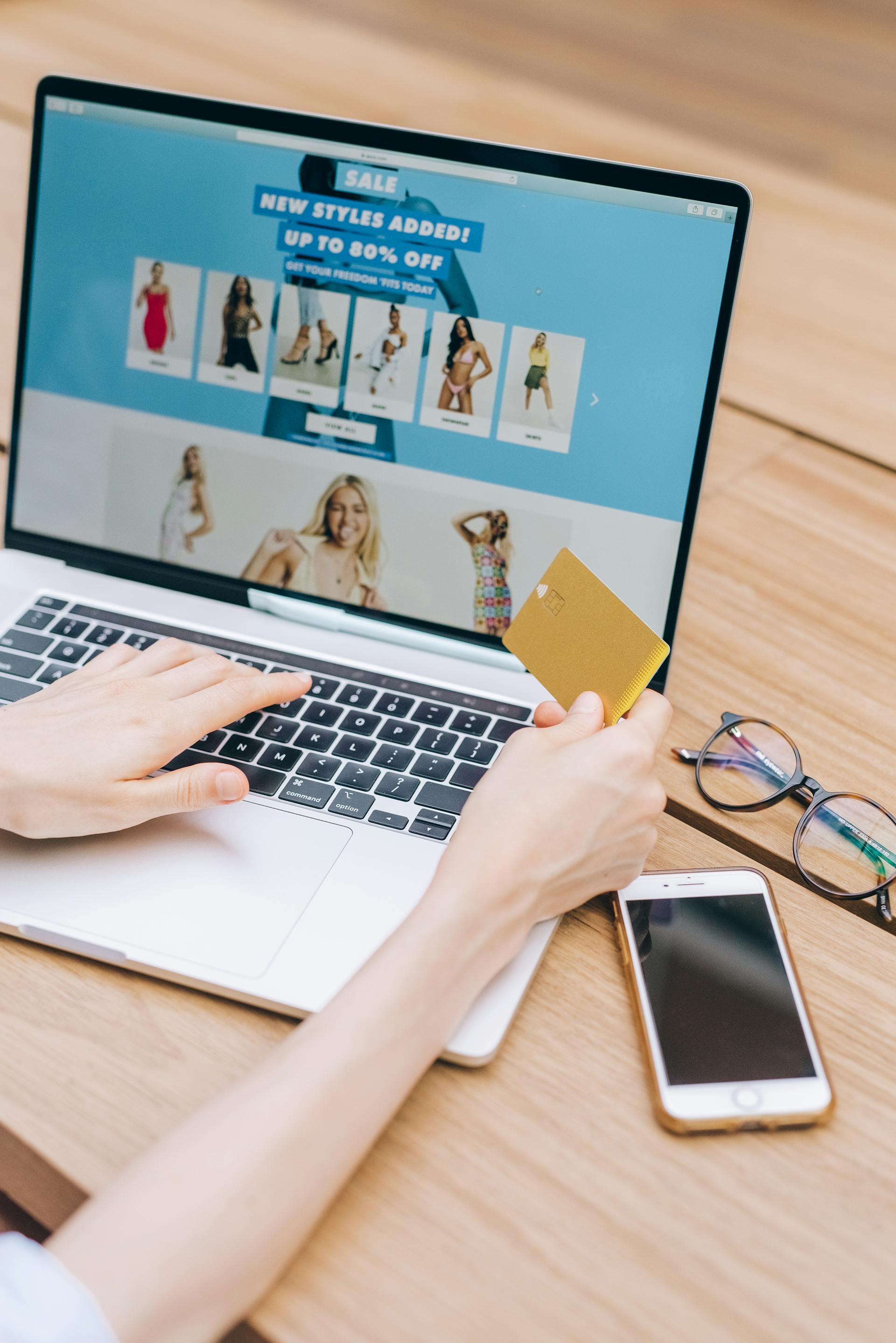 A closeup of a person holding their bank card while shopping online | Source: Pexels