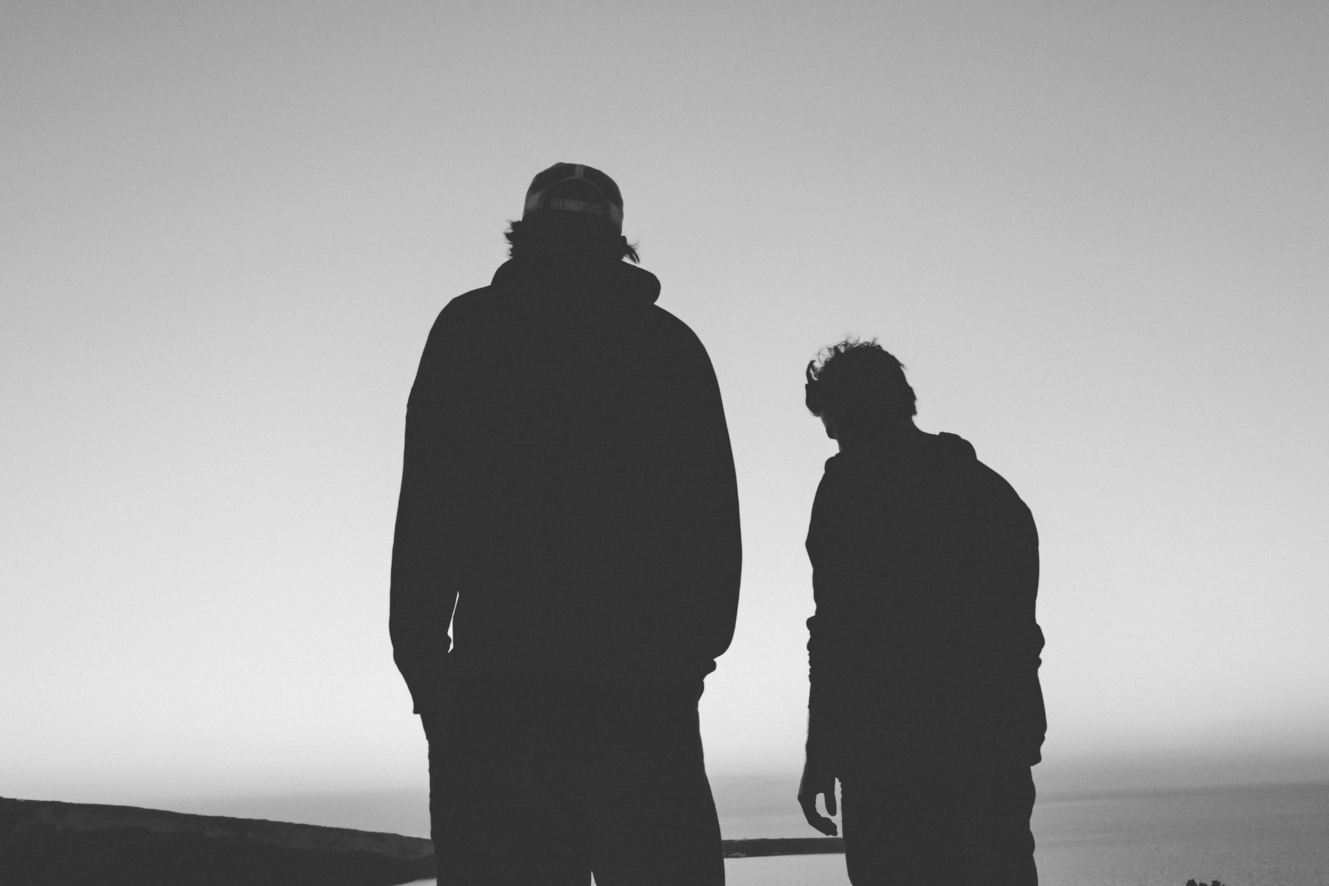 Silhouette of two men | Source: Unsplash