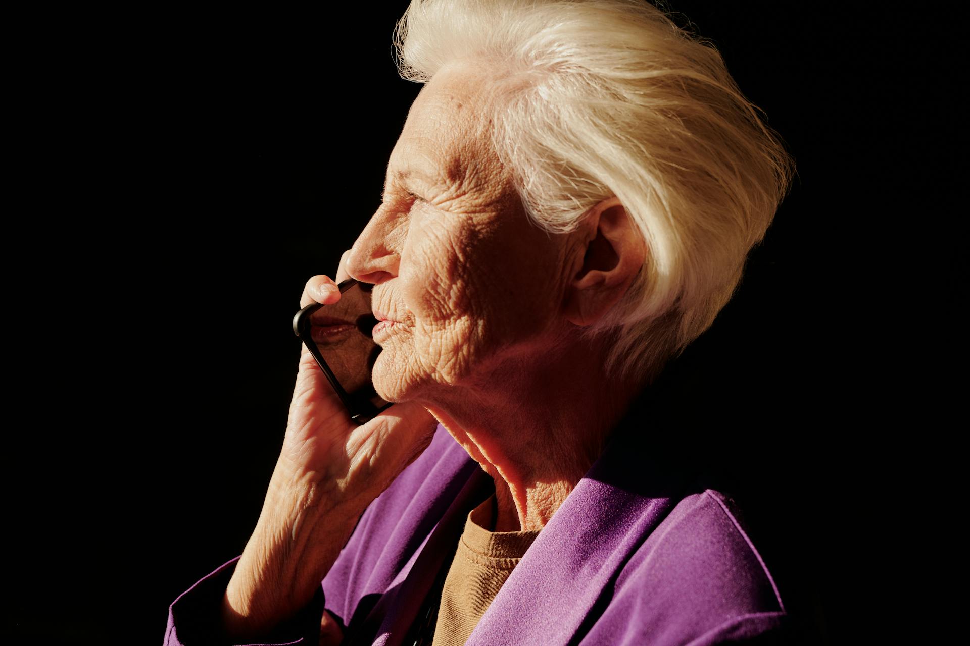 An elderly woman having a serious phone conversation | Source: Pexels