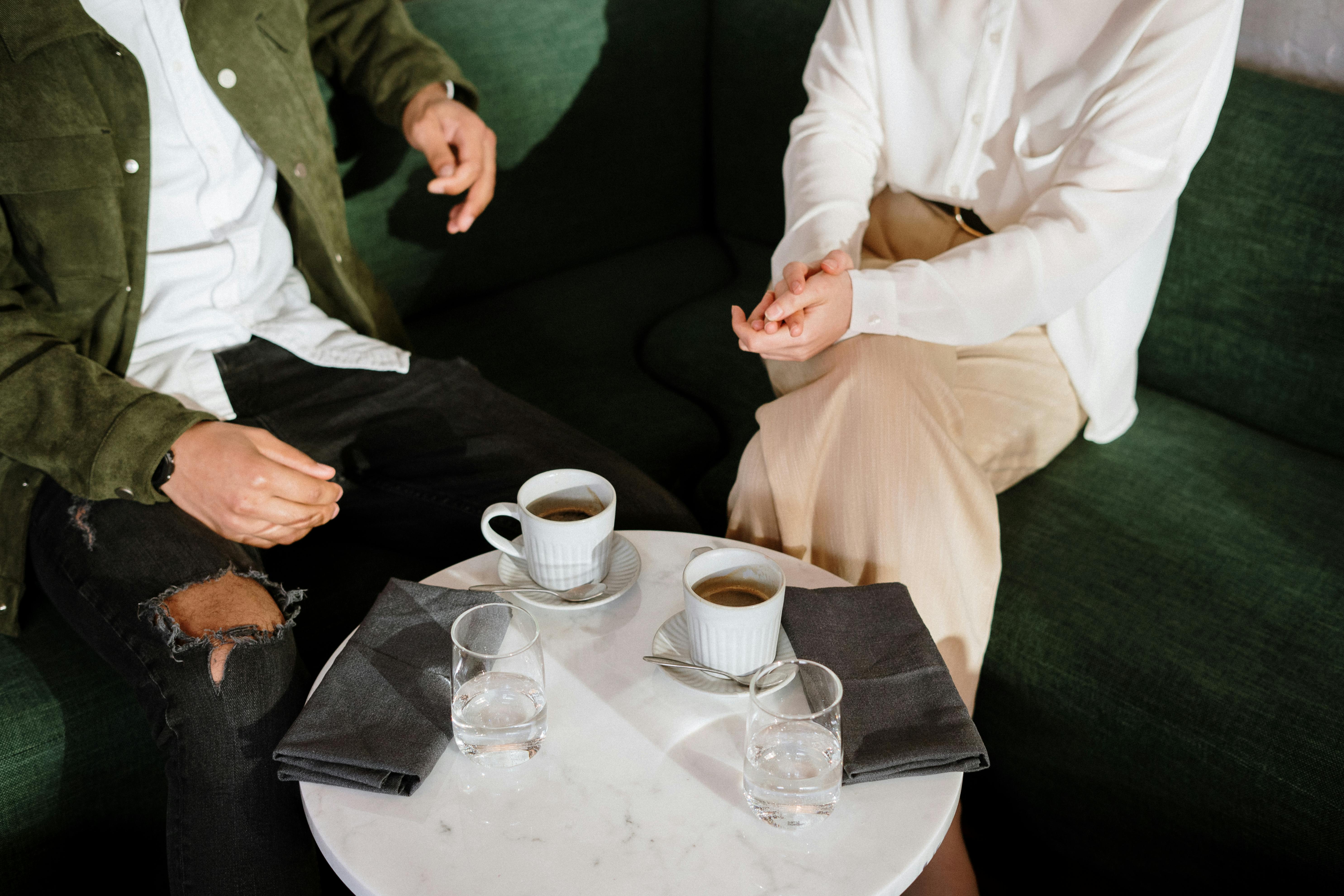 A couple sitting at a restaurant drinking coffee | Source: Pexels