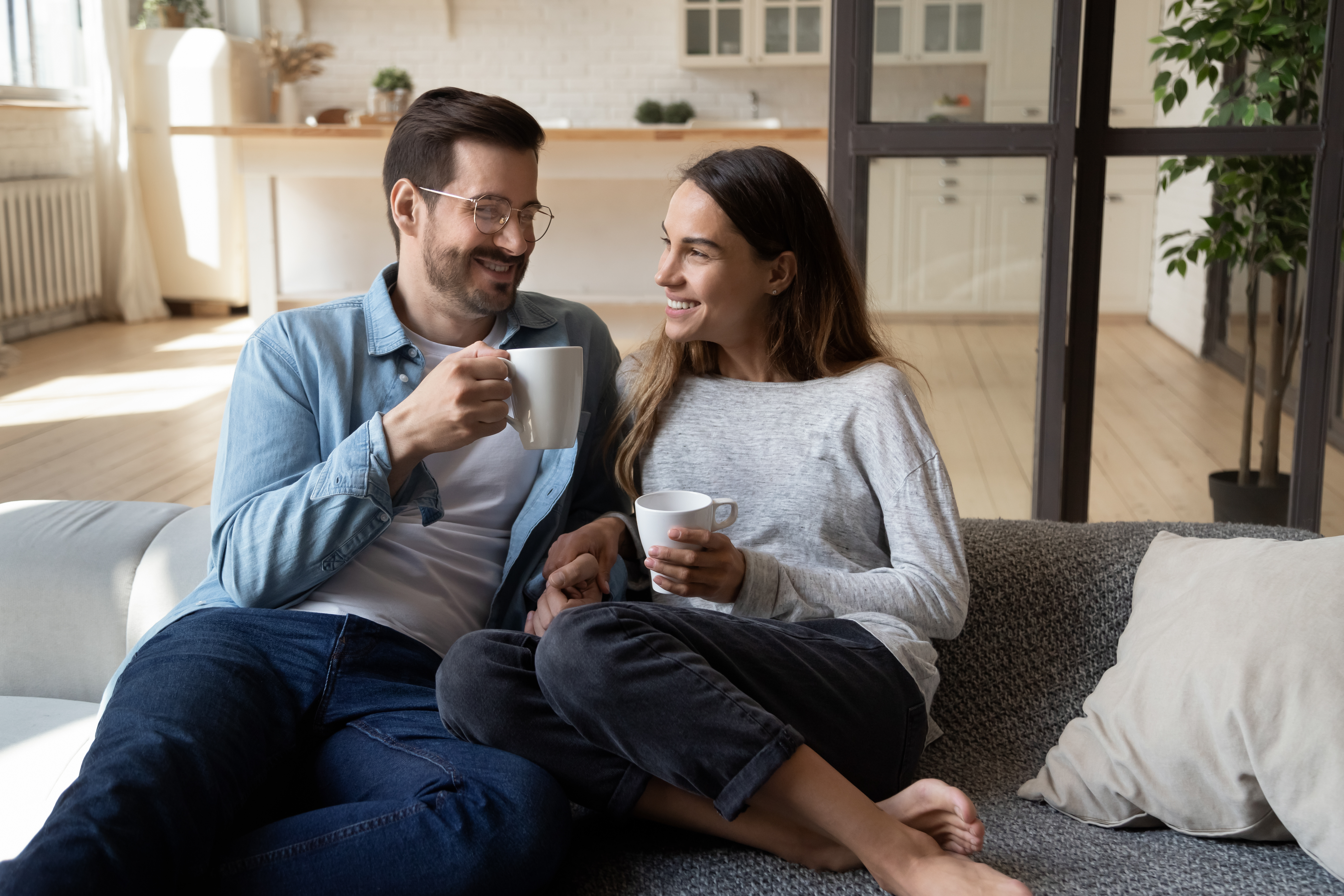 A couple smiling while sitting together | Source: Shutterstock