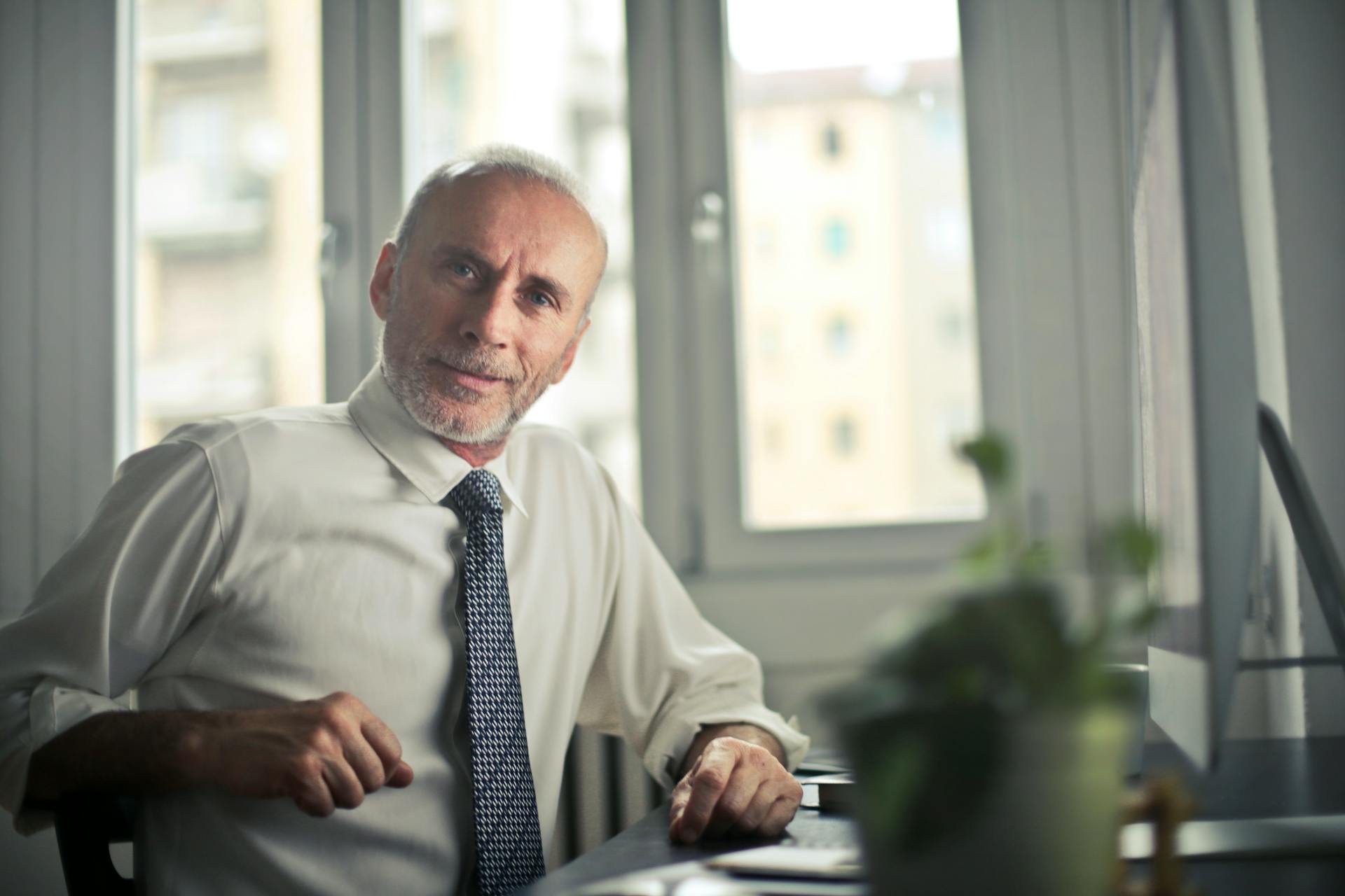 A middle-aged man sitting at his desk | Source: Pexels