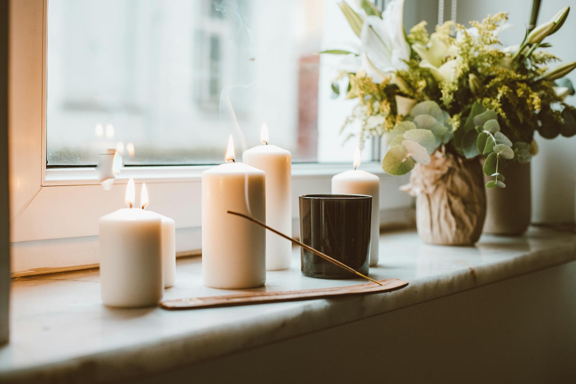 Candles and incense on windowsill | Source: Pexels