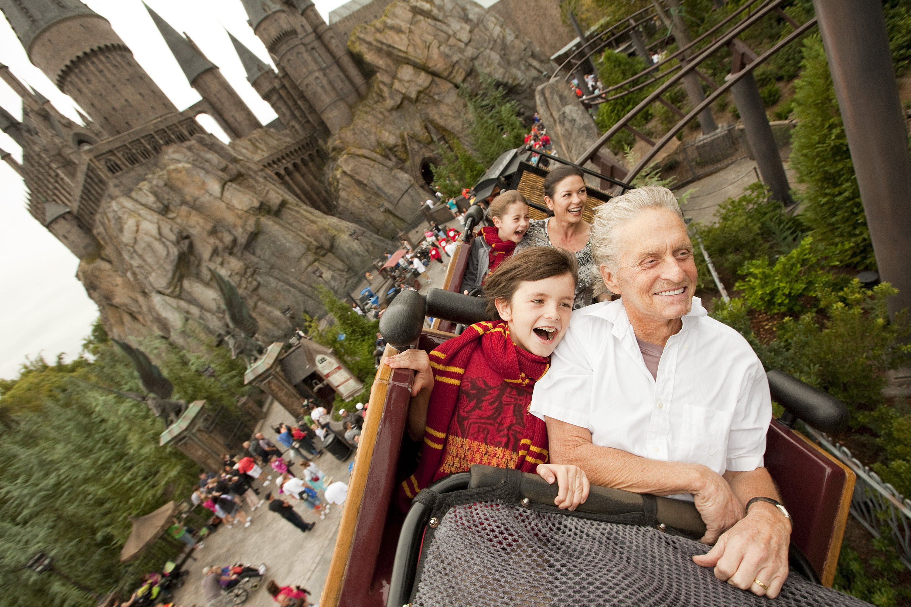 Michael Douglas and Catherine Zeta-Jones, along with their children Dylan, 10, and Carys, 7, fly over The Wizarding World of Harry Potter and past Hogwarts Castle while riding Flight of the Hippogriff at Universal Orlando Resort on November 27, 2010, in Orlando, Florida. | Source: Getty Images