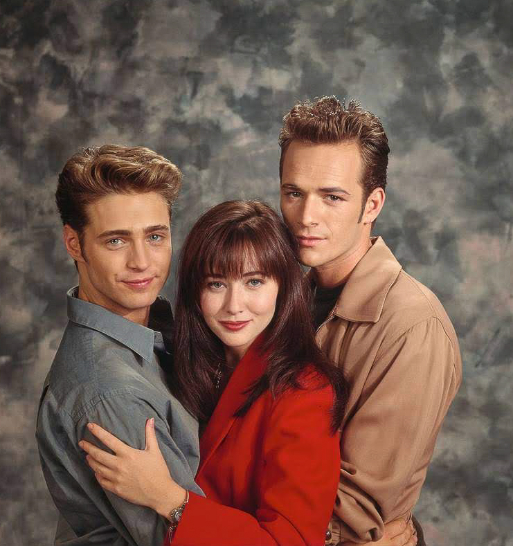 Luke Perry, Shannen Doherty, and Jason Priestley on the set of "Beverly Hills, 90210," circa 1991. | Source: Getty Images