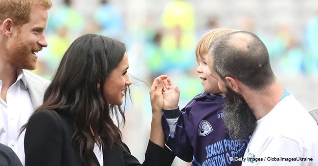 Baby couldn't stop touching Meghan Markle's hair, so Prince Harry sweetly rebuked him