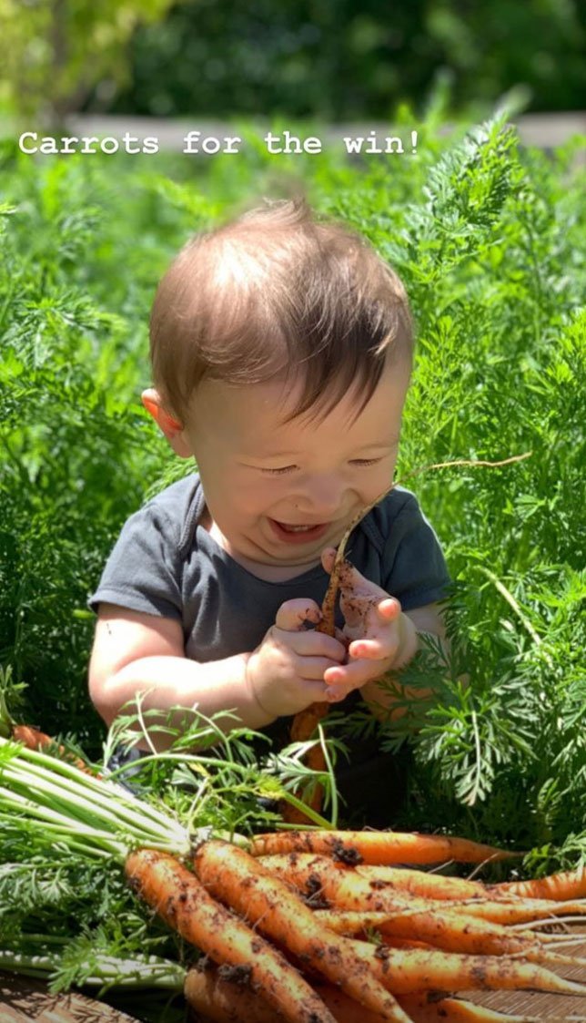 Baby Crew playing with carrots in his first Easter | Photo: Instagram/Joanna Gaines