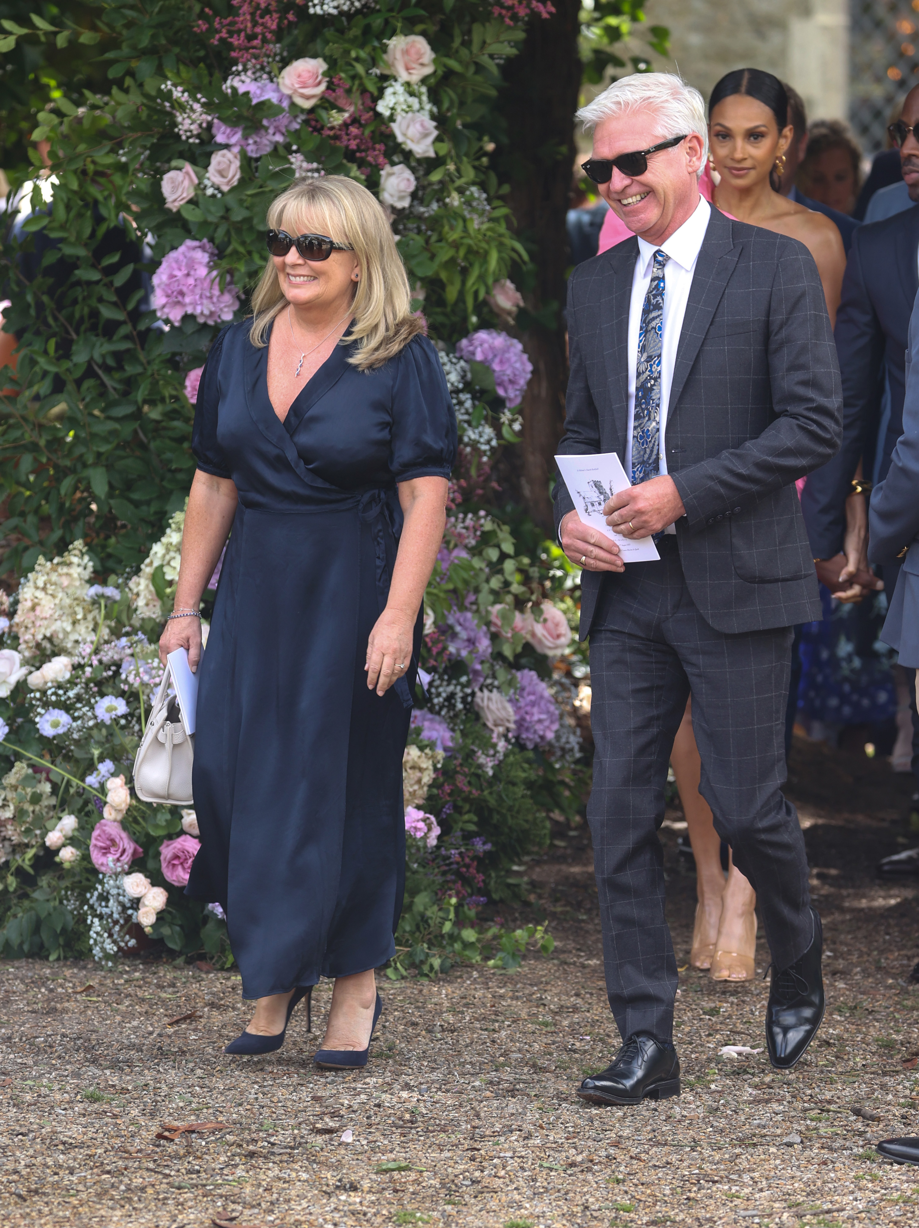 Phillip Schofield and Stephanie Lowe seen departing the wedding of Ant McPartlin and Anne-Marie Corbett on August 7, 2021, in Hook, Hampshire. | Source: Getty Images