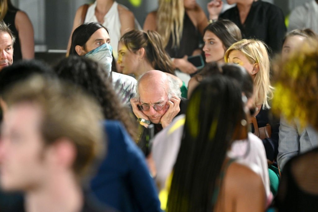 Larry David plugs his ears at the STAUD runway show during New York Fashion Week, September 2021 | Source: Getty Images