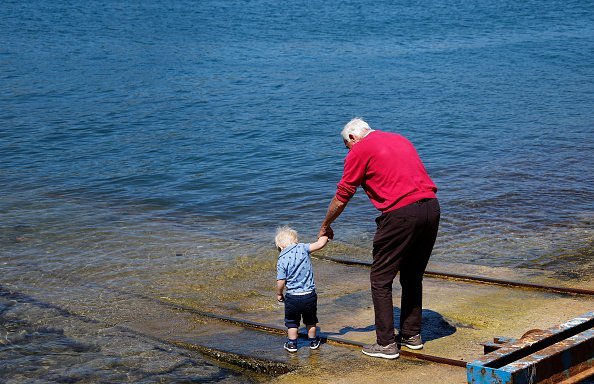 Photo of a Grandpa and his Grandson having a good time | Photo: Getty Images