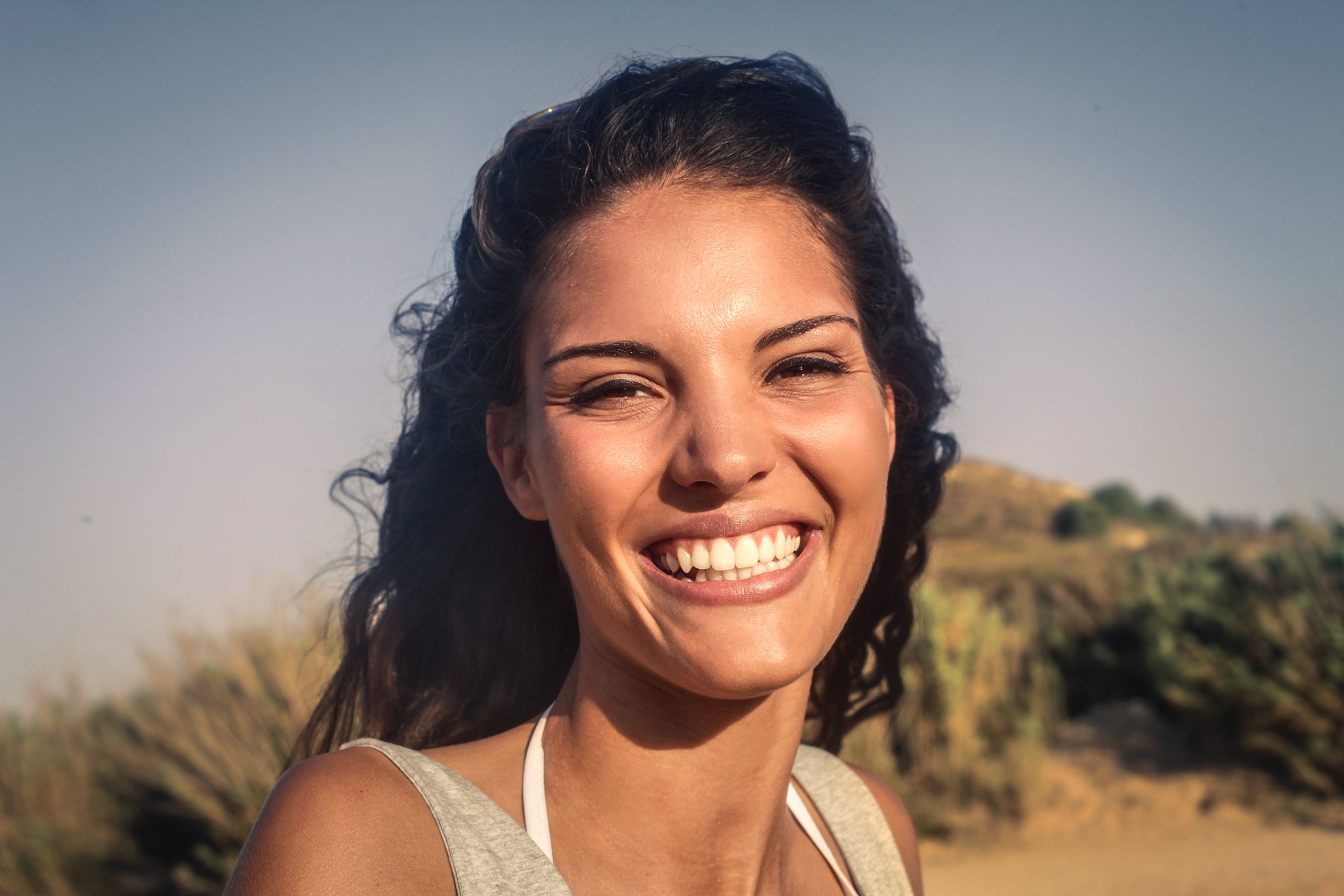 A woman smiling. │Source: Shutterstock