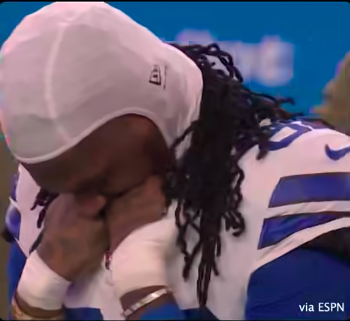 A Dallas Cowboy player pressing his fists to his face as he mourns his late teammate, Marshawn Kneeland, during the moment of silence, posted on November 17, 2025. | Source: Facebook/Dallas Cowboys on CBS Sports