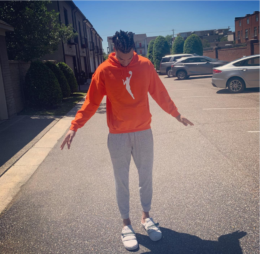 Brandon Clarke stands outside in an orange hoodie and gray sweatpants. | Source: Instagram/brandon_clarke23