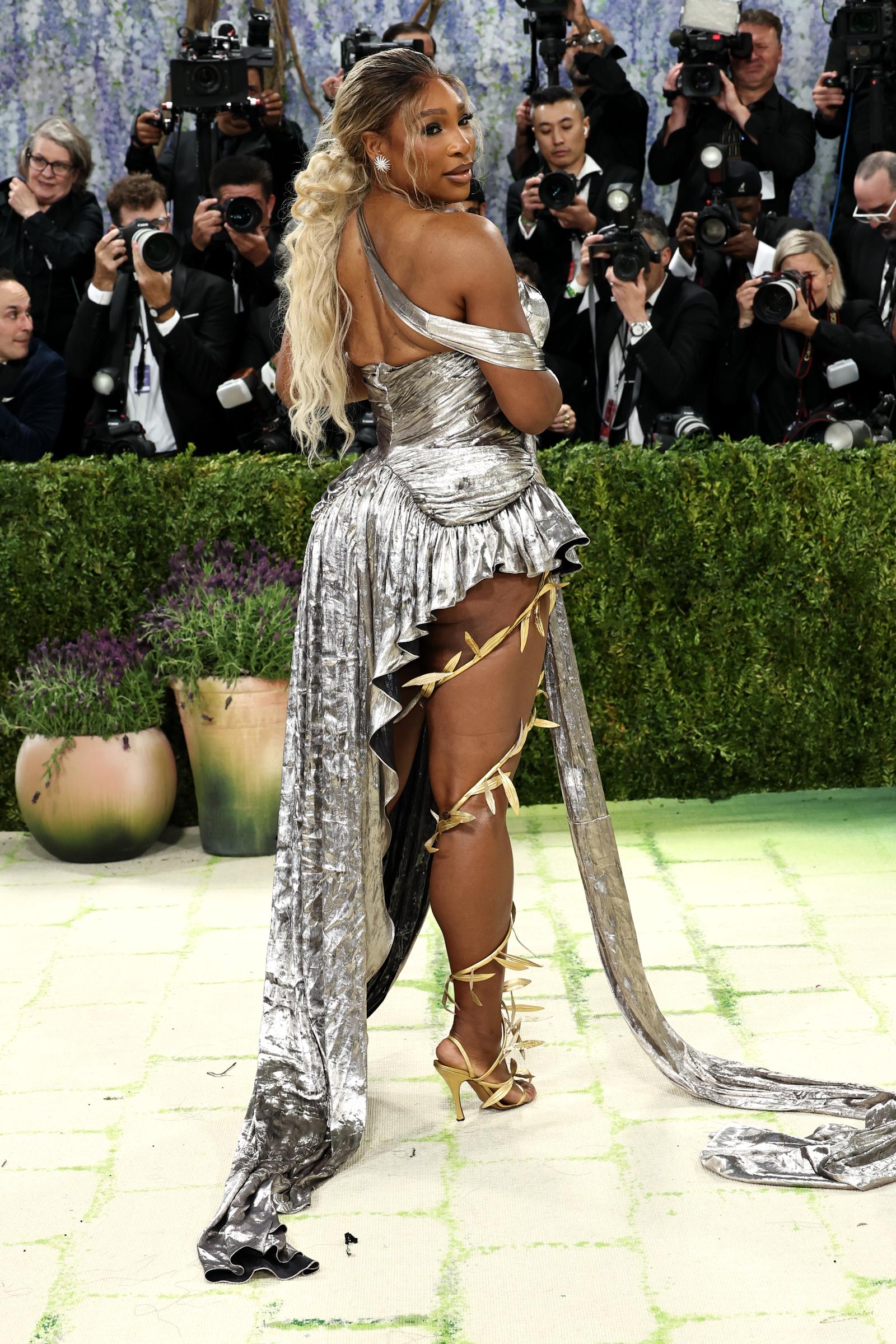 Serena Williams looks over her shoulder, showcasing the dramatic train of her gown at the 2026 Met Gala in New York City | Source: Getty Images