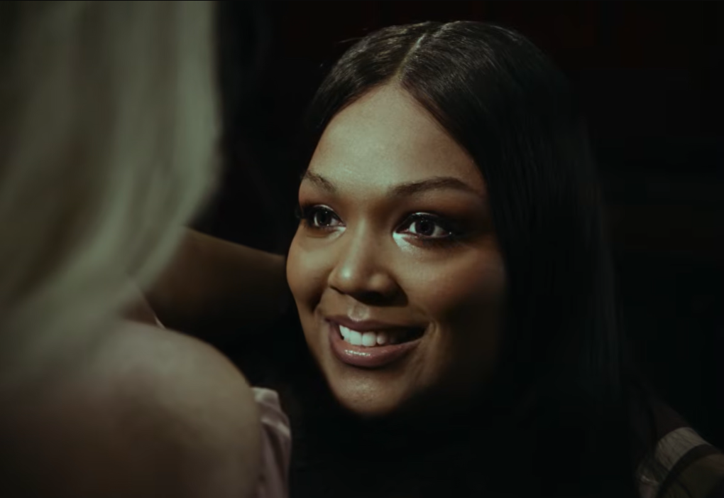 The exchange softens as Lizzo’s alter ego responds with a smile | Source: YouTube/Lizzo