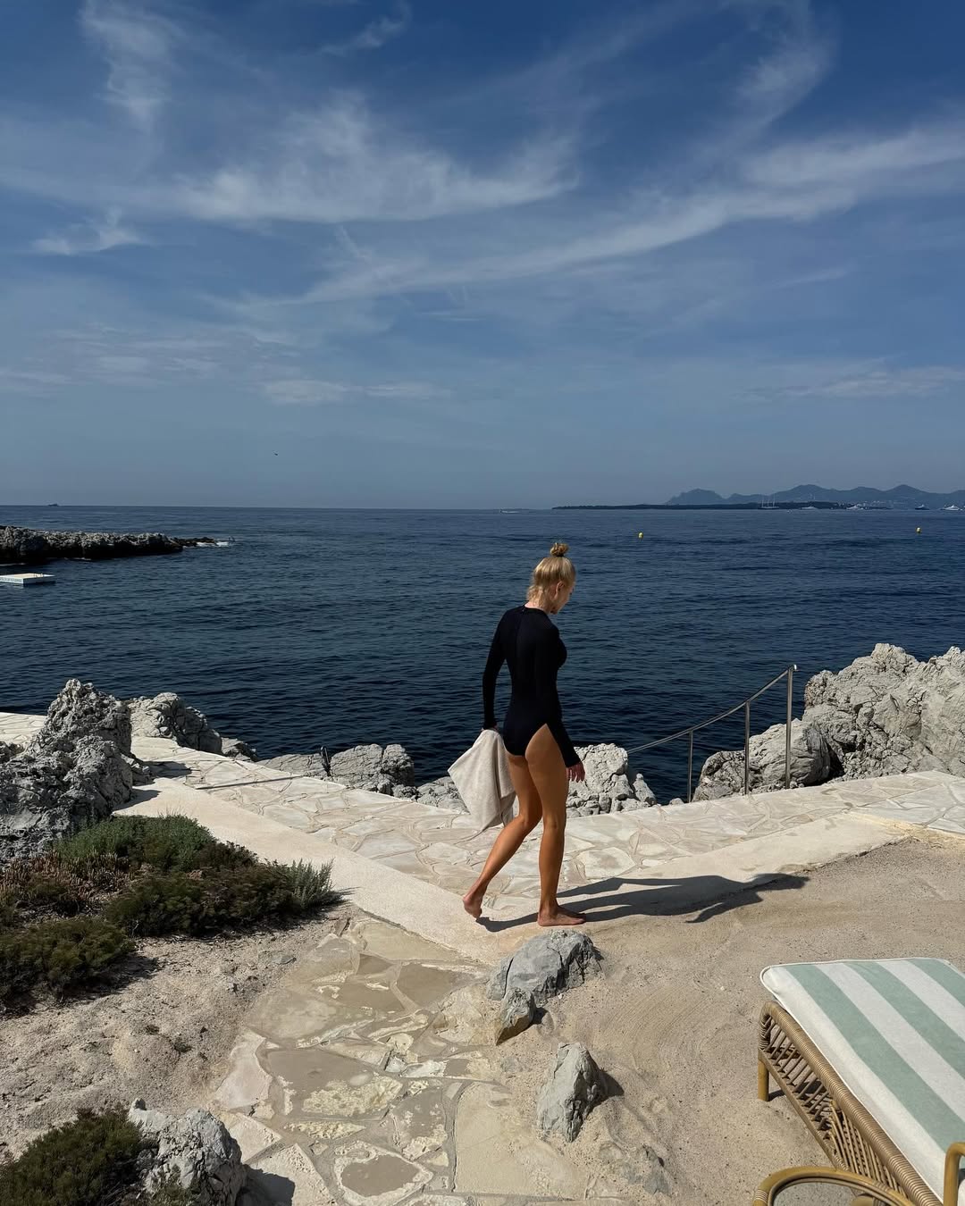 Nicole Kidman wearing a long-sleeved bathing suit and holding a towel near the sea in Côte d’Azur, France, from her post dated May 19, 2025 | Source: Instagram/nicolekidman