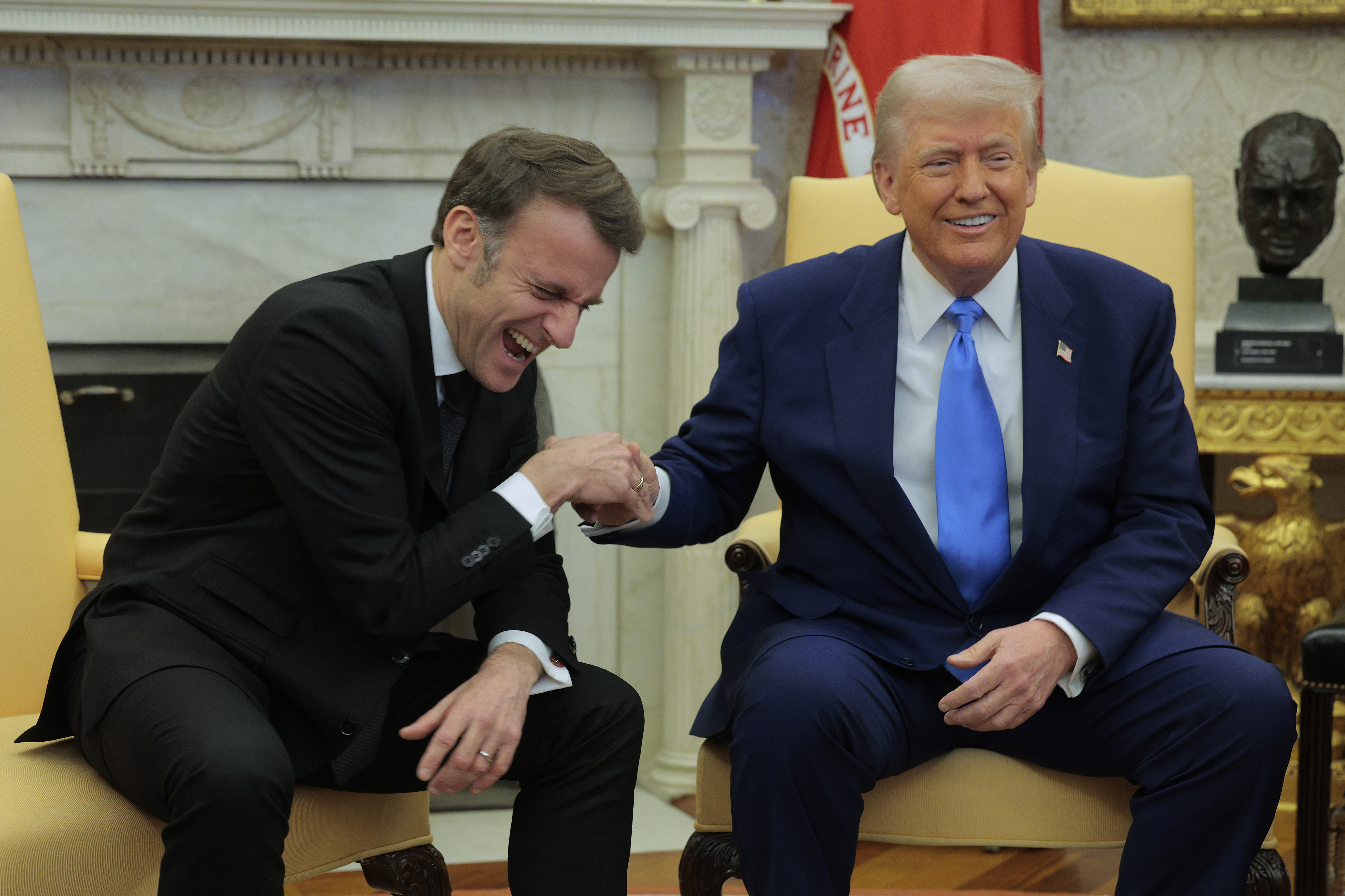 Emmanuel Macron laughing with Donald Trump during their meeting in the Oval Office in Washington, D.C., on February 24, 2025. | Source: Getty Images