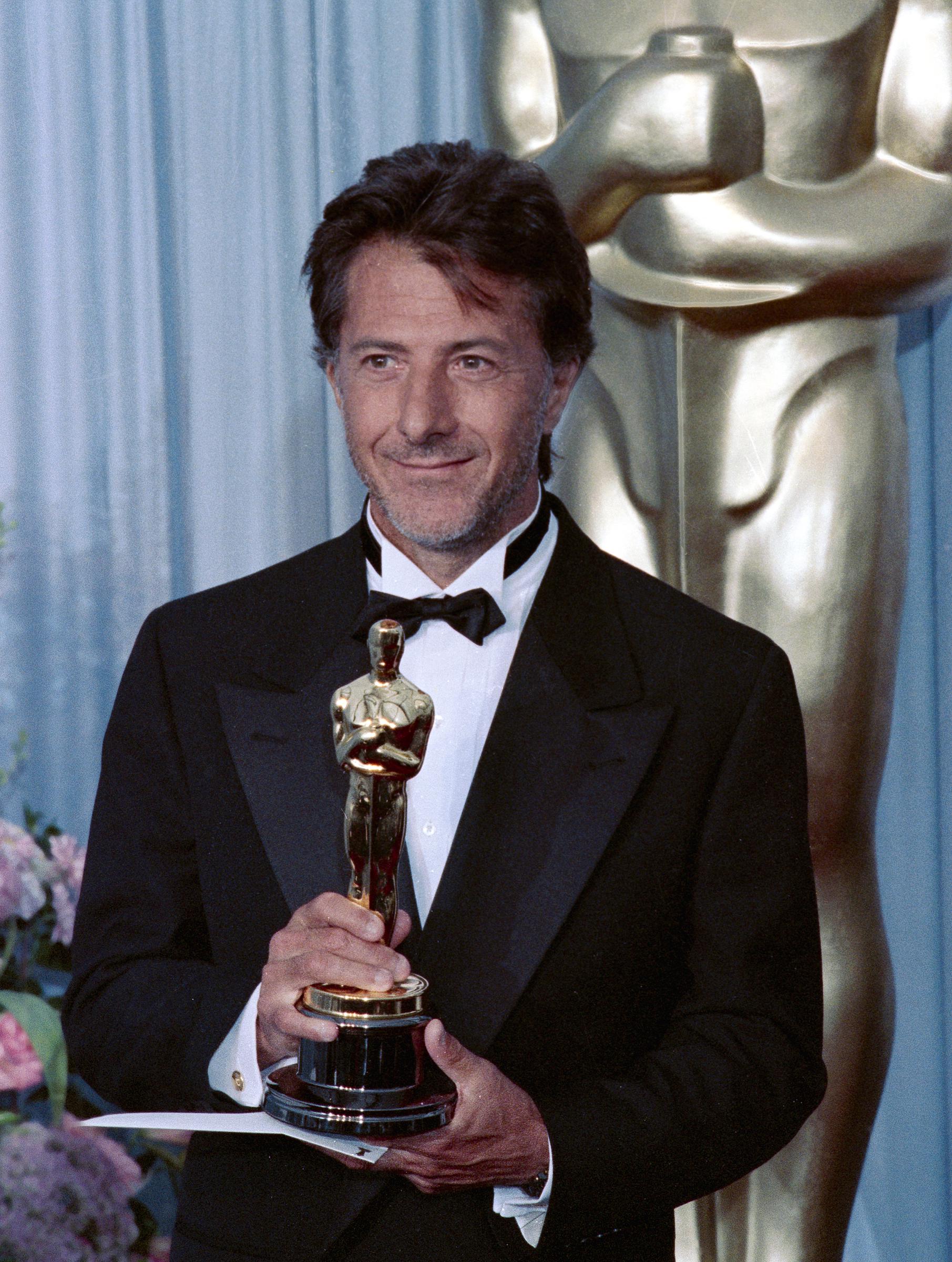 Dustin Hoffman receives a Best Actor Academy Award for his performance in the 1988 film, 