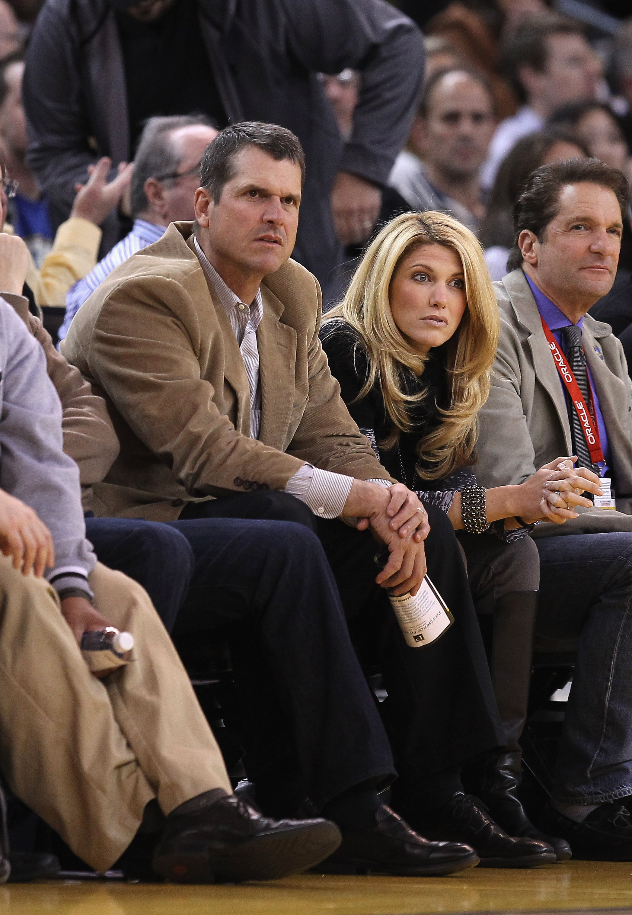 Jim Harbaugh and his wife, Sarah, watch a game at Oracle Arena on February 15, 2012, in Oakland, California | Source: Getty Images