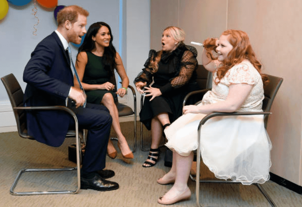 Prince Harry and Meghan Markle chats with award recipient Milly Sutherland and her mother, Angela Sutherland at the WellChild awards pre-Ceremony reception, on October 15, 2019 in London, England | Source: Toby Melville - WPA Pool/Getty Images