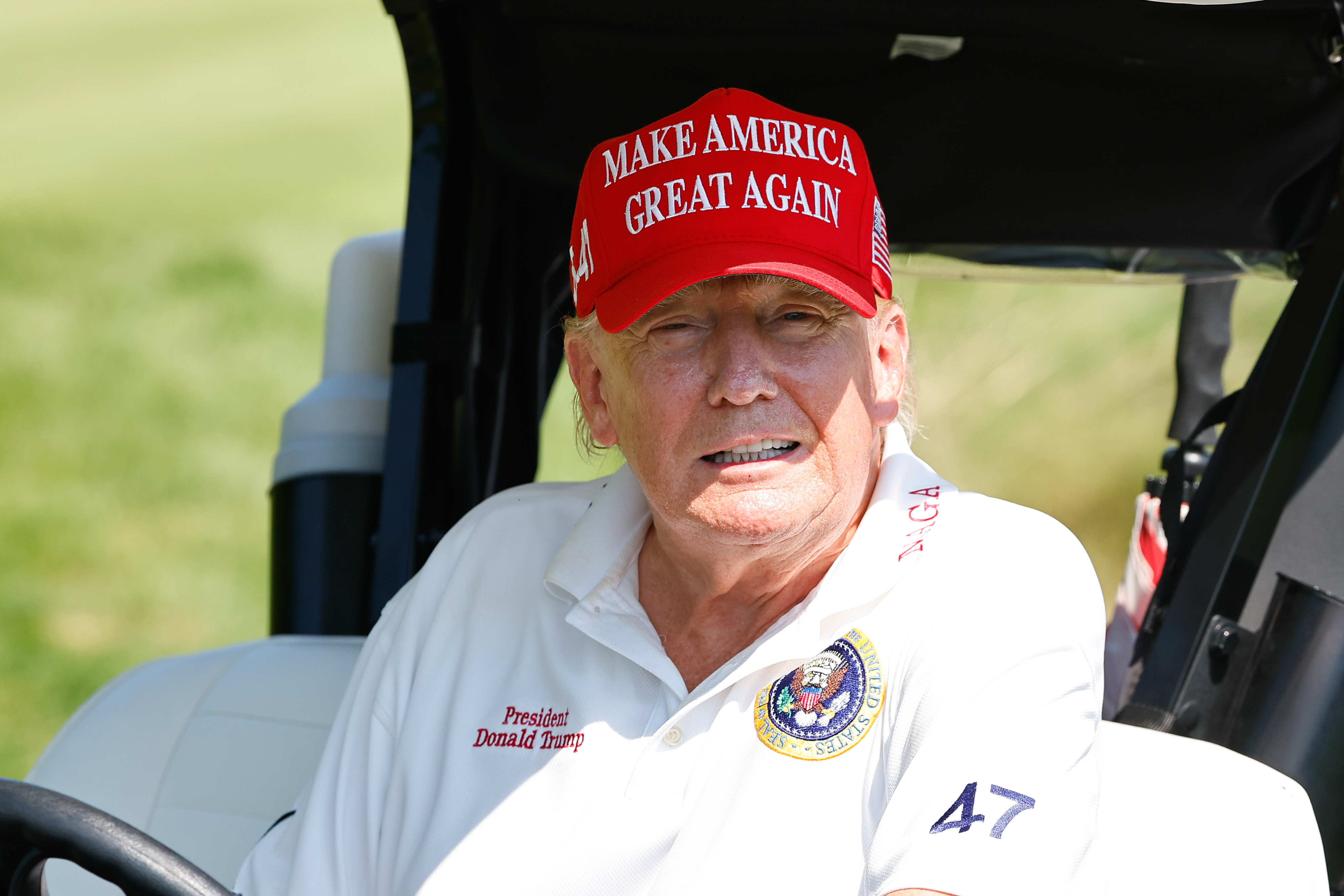 President Donald Trump drives away from the 15th tee during the practice round at Trump National Golf Club on August 9, 2023, in Bedminster, New Jersey | Source: Getty Images