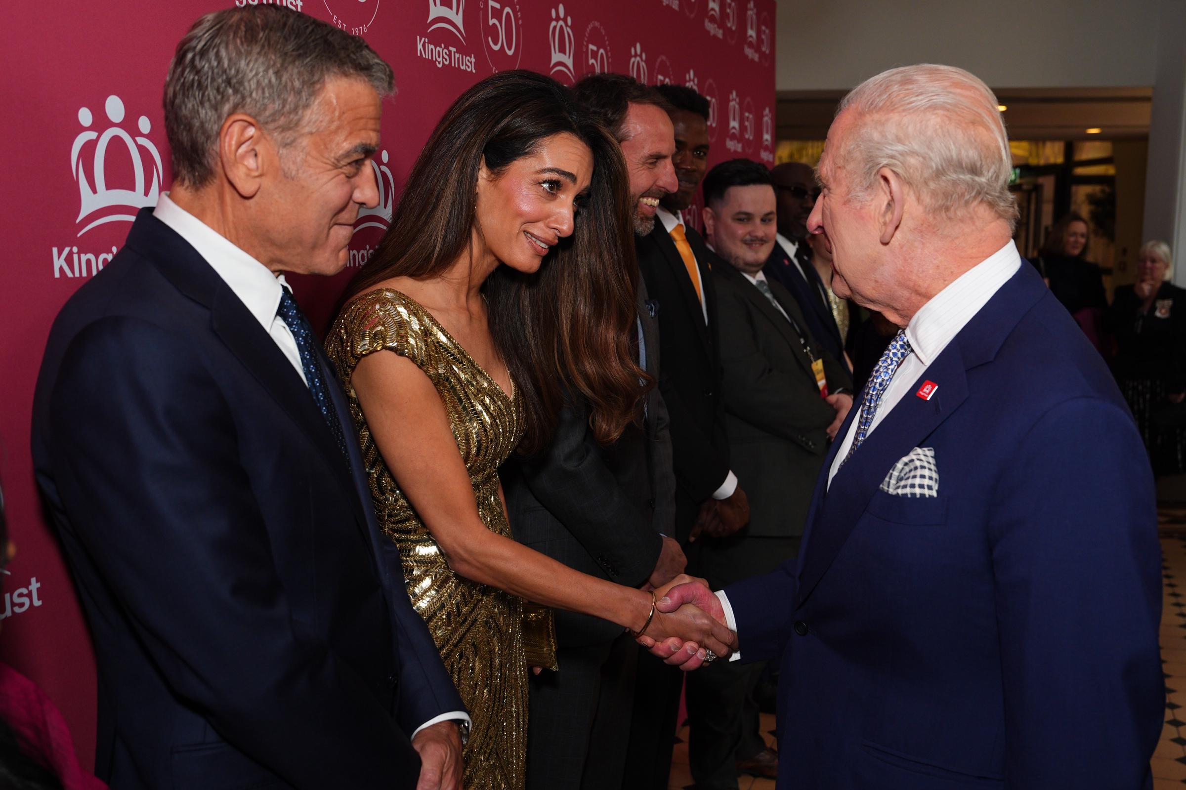 Amal and George Clooney meet King Charles III during "The King's Trust 50th Anniversary Celebration" at Royal Albert Hall on May 11, 2026 in London, England. | Source: Getty Images