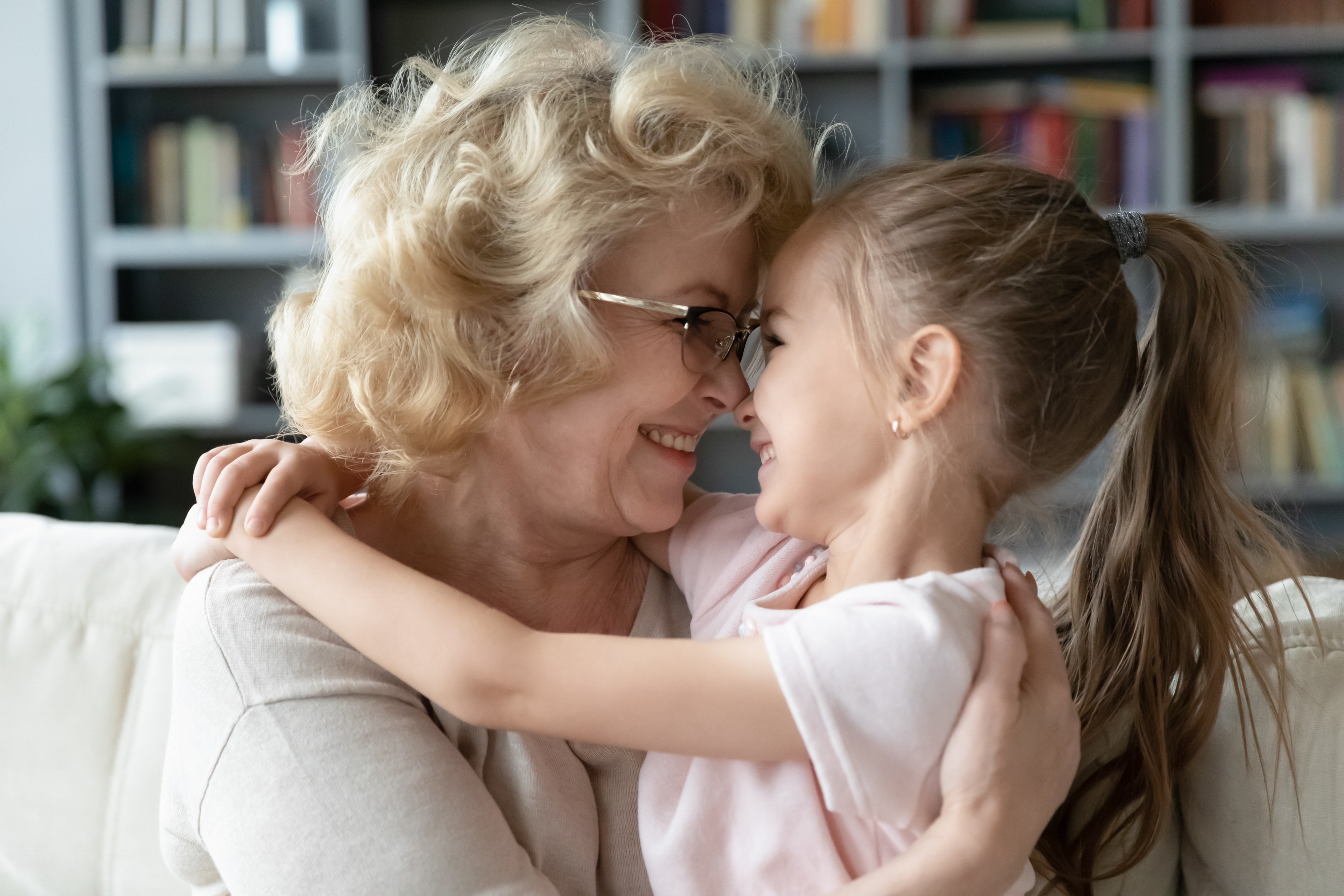 A happy grandmother hugging her young granddaughter | Source: Shutterstock