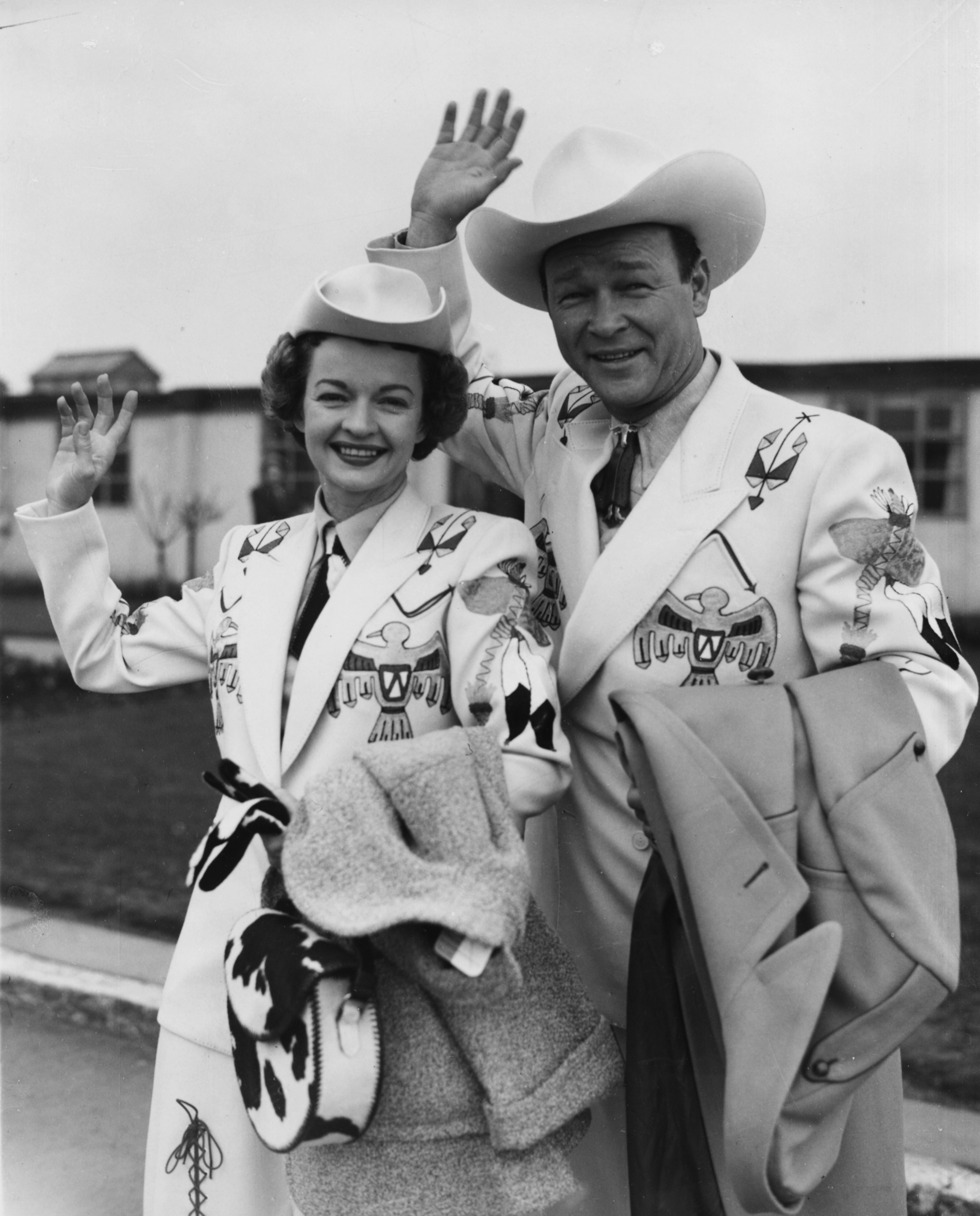  Roy Rogers, the 'King of Cowboys', and his wife Dale Evans in 'Wild West' costume, waving as they arrive at London Airport, February 10th 1954. | Source: Getty Images.