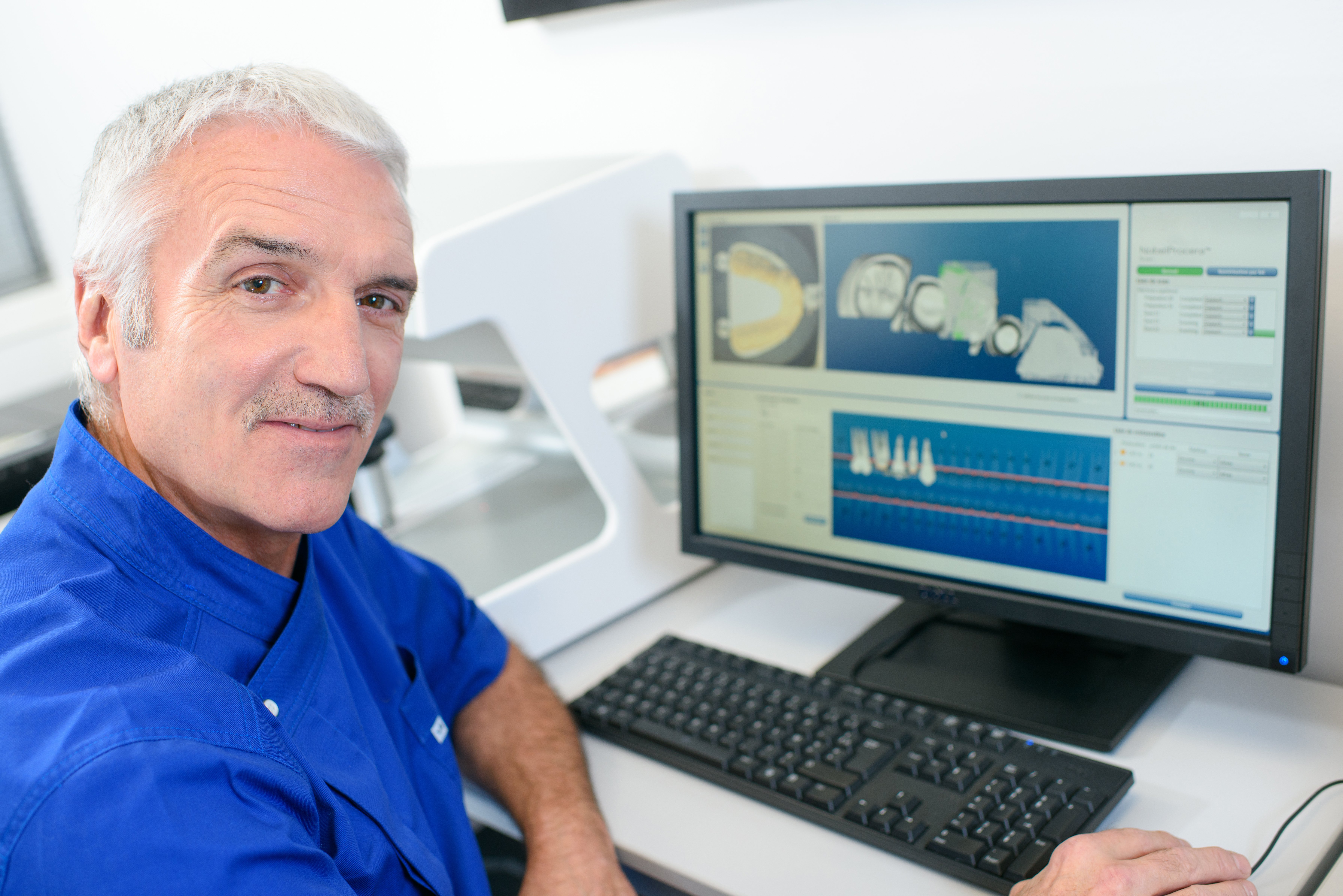 Dentist sitting in front of his computer | Photo: Shutterstock