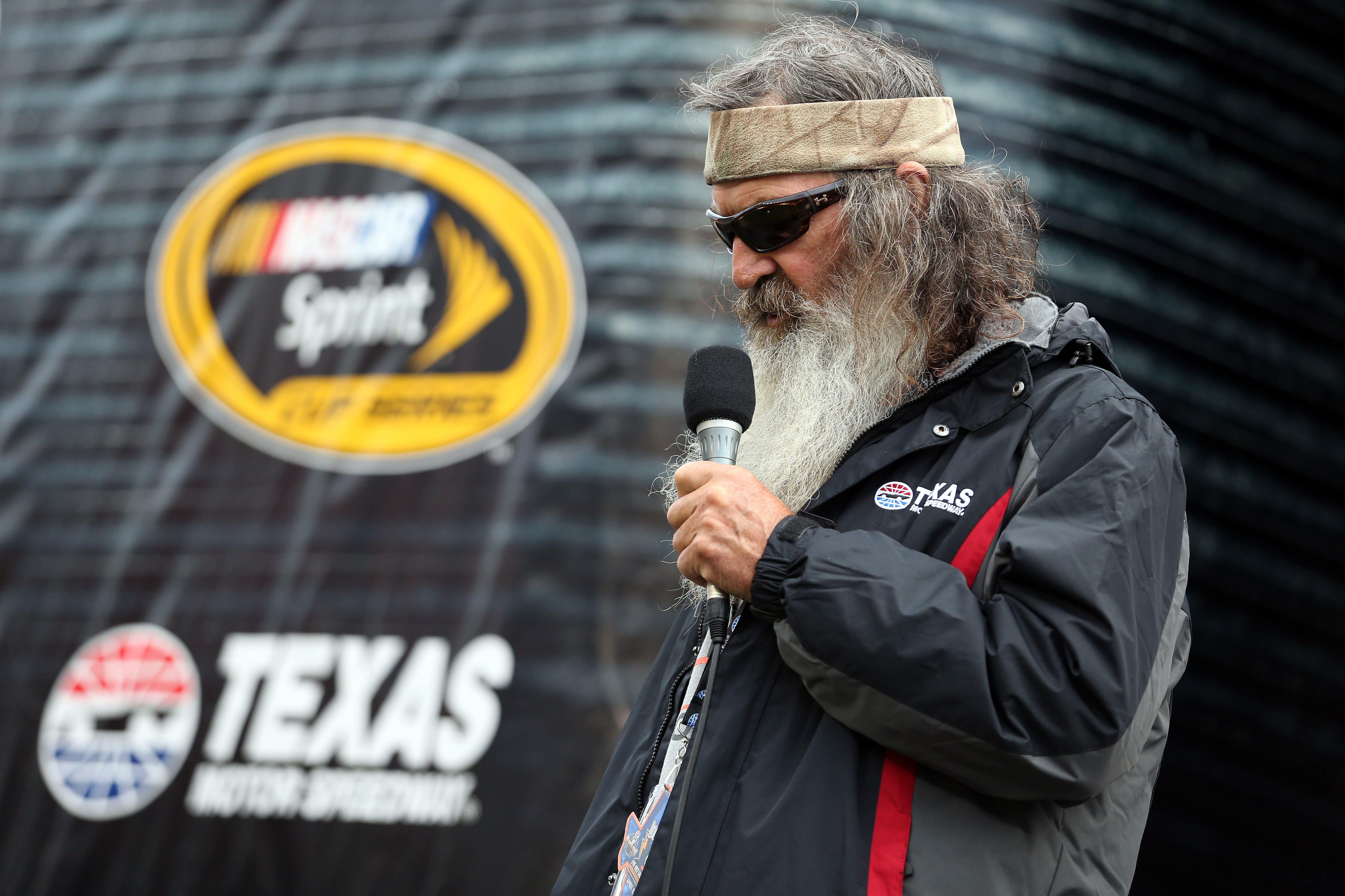 Phil Robertson delivers the invocation before the NASCAR Sprint Cup Series Duck Commander 500 at Texas Motor Speedway in Fort Worth, Texas on April 9, 2016 | Source: Getty Images