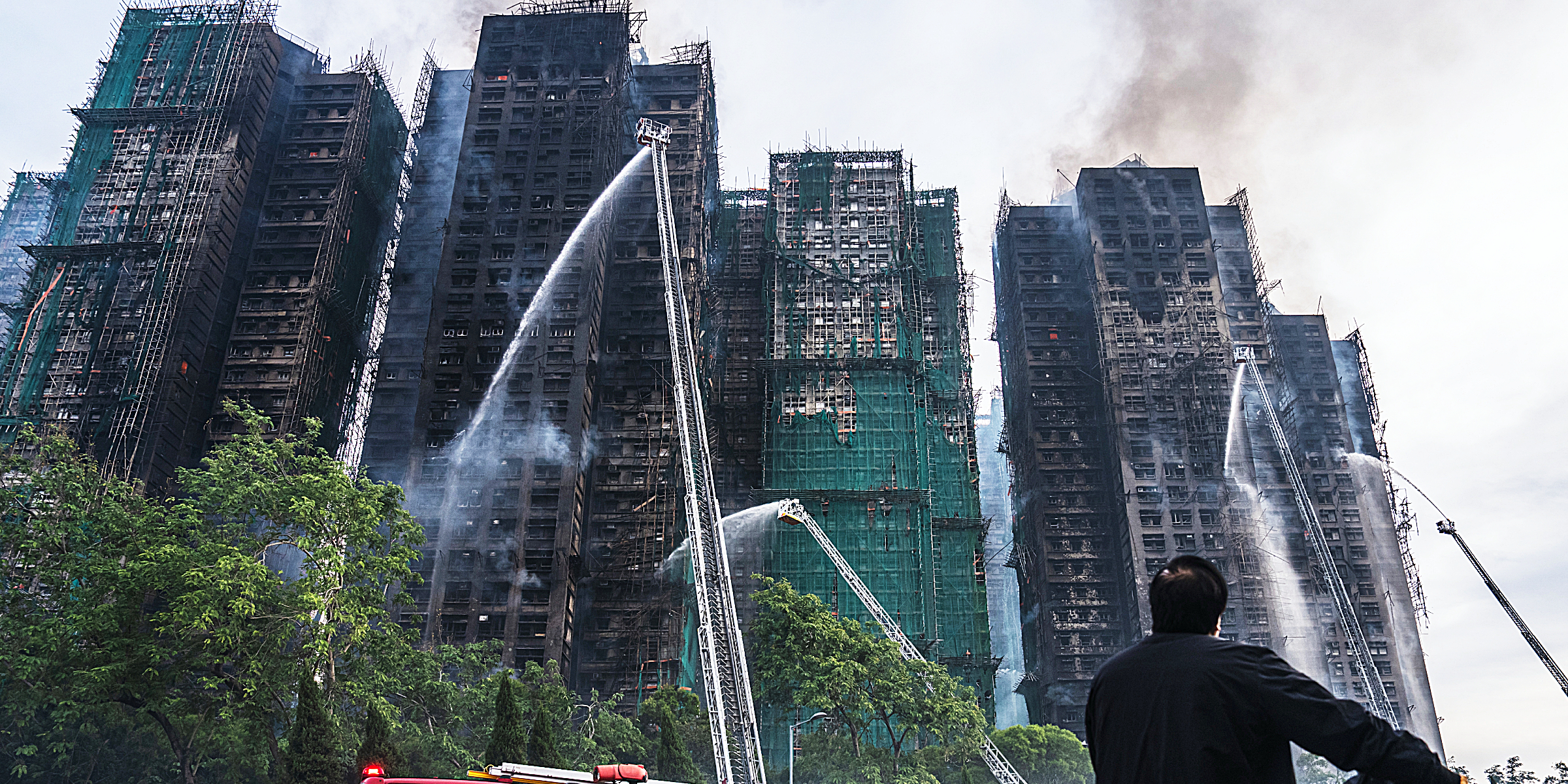 Firefighters douse burning towers in Hong Kong | Source: Getty Images