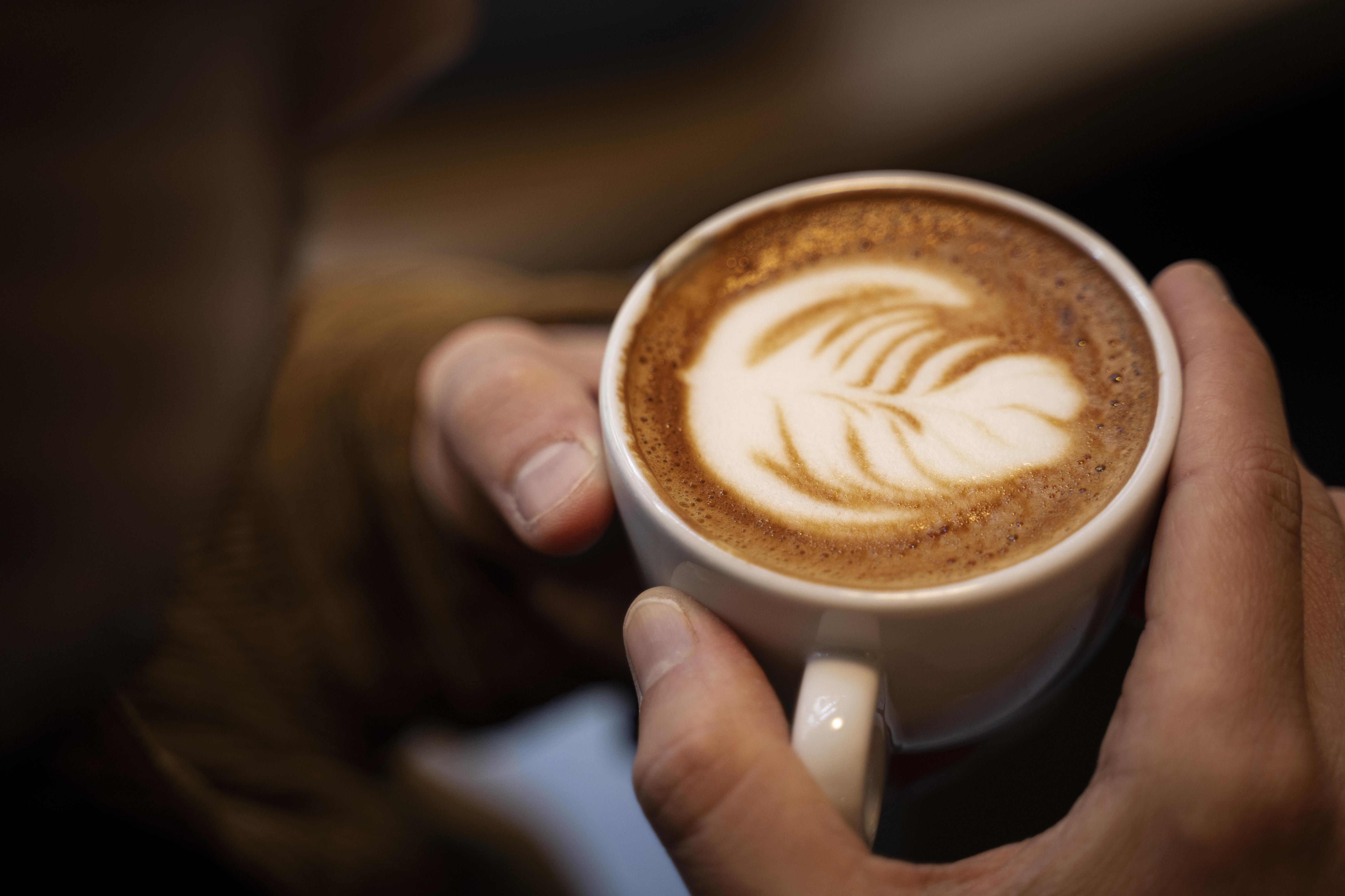 A person holding a cup of coffee | Source: Freepik