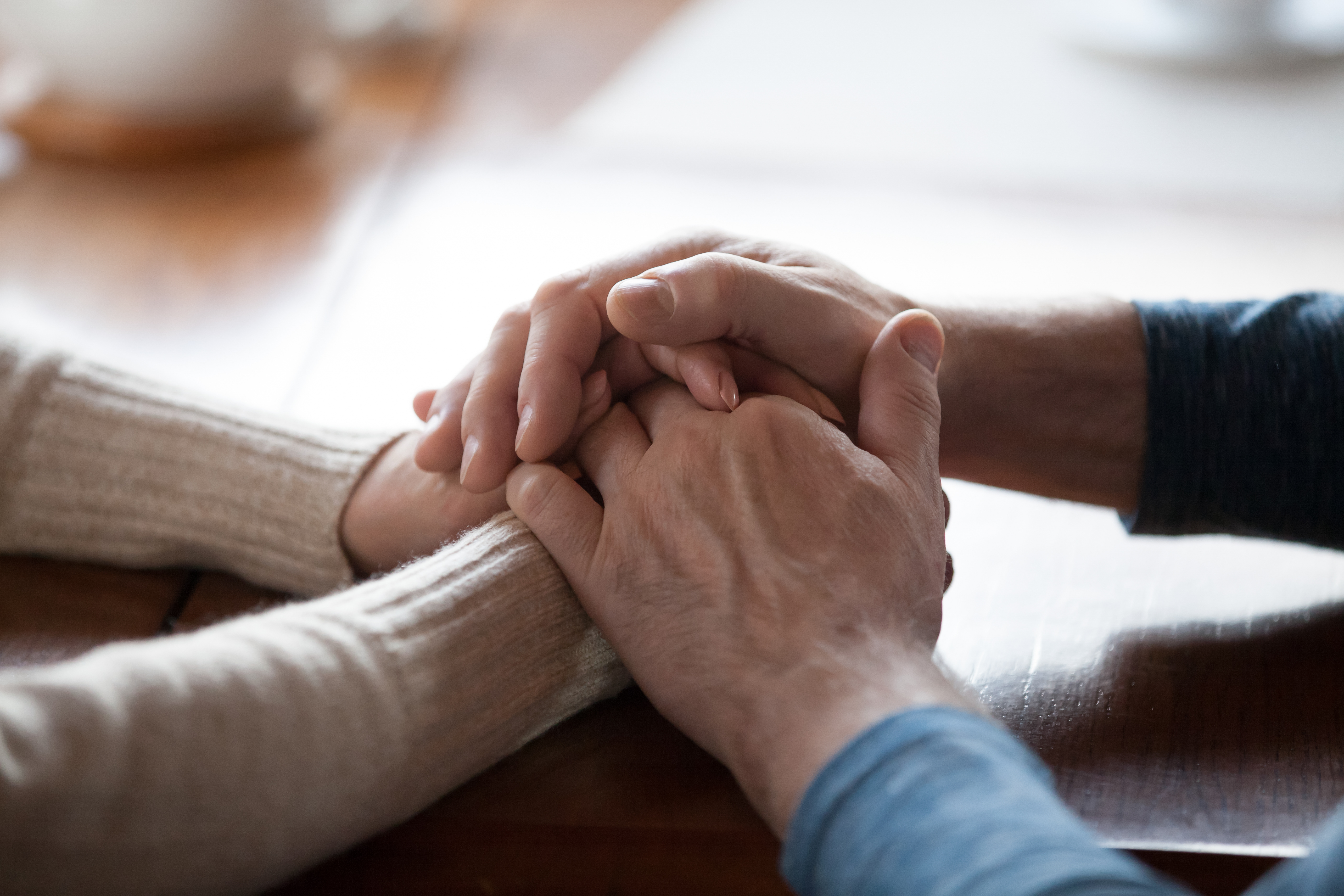 A senior couple holding hands | Source: Shutterstock