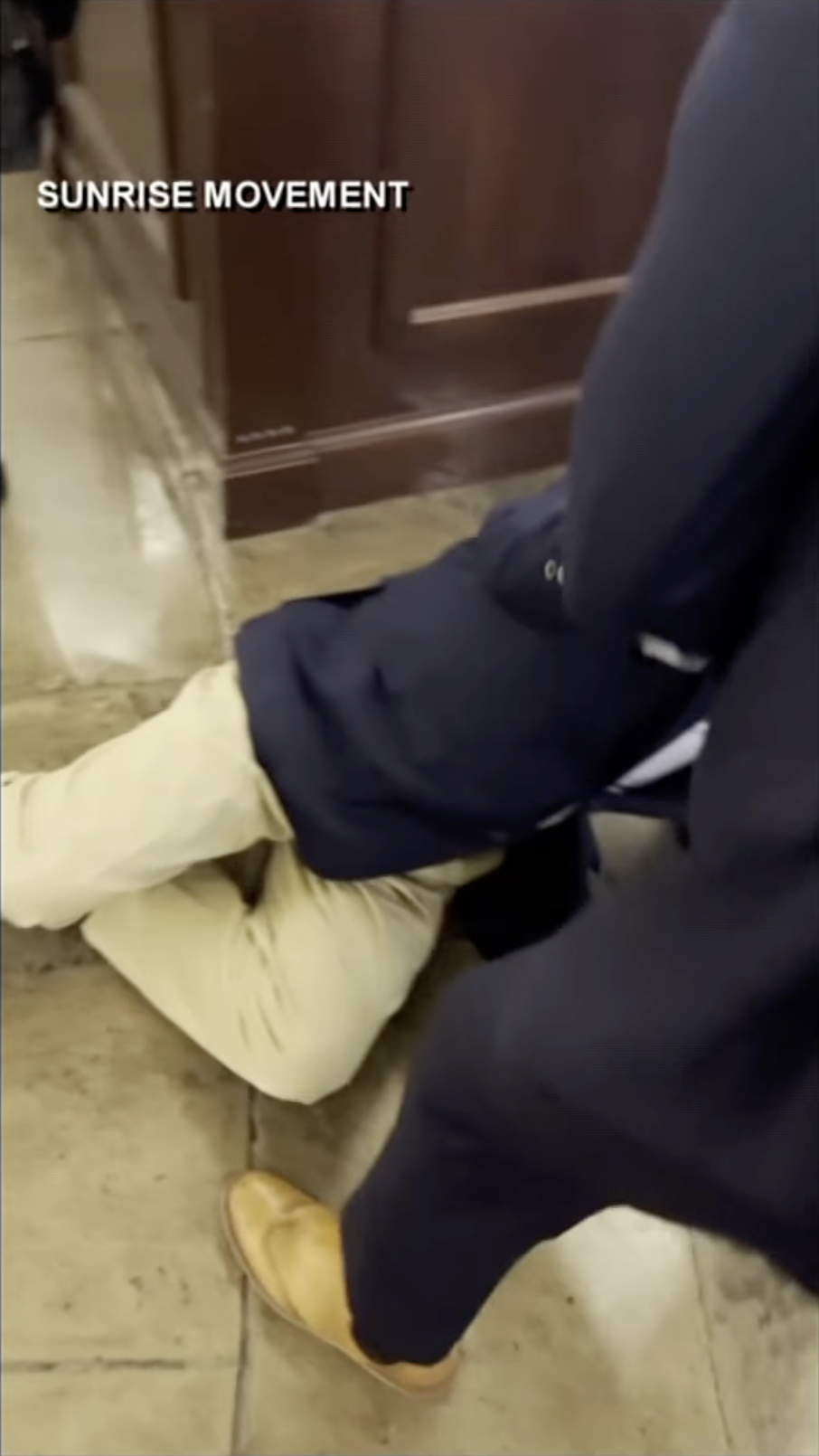 Senator Mitch McConnell lies on the Capitol floor as individuals around him prepare to help him back up, as posted on October 16, 2025 | Source: YouTube/WHAS11News
