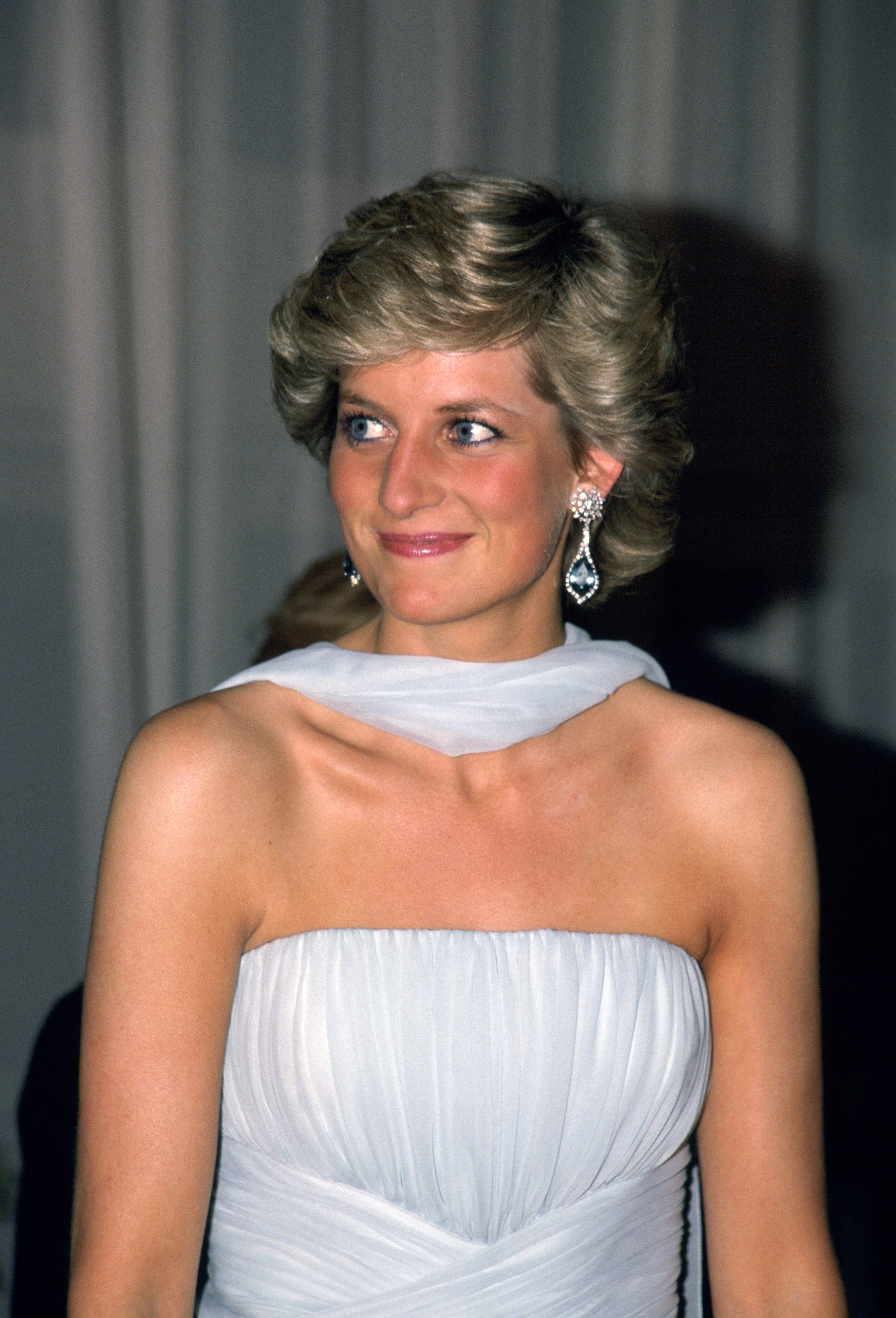 Diana, Princess of Wales attends the Cannes film festival wearing a pale blue chiffon dress and wrap designed by fashion designer Catherine Walker | Source: Getty Images