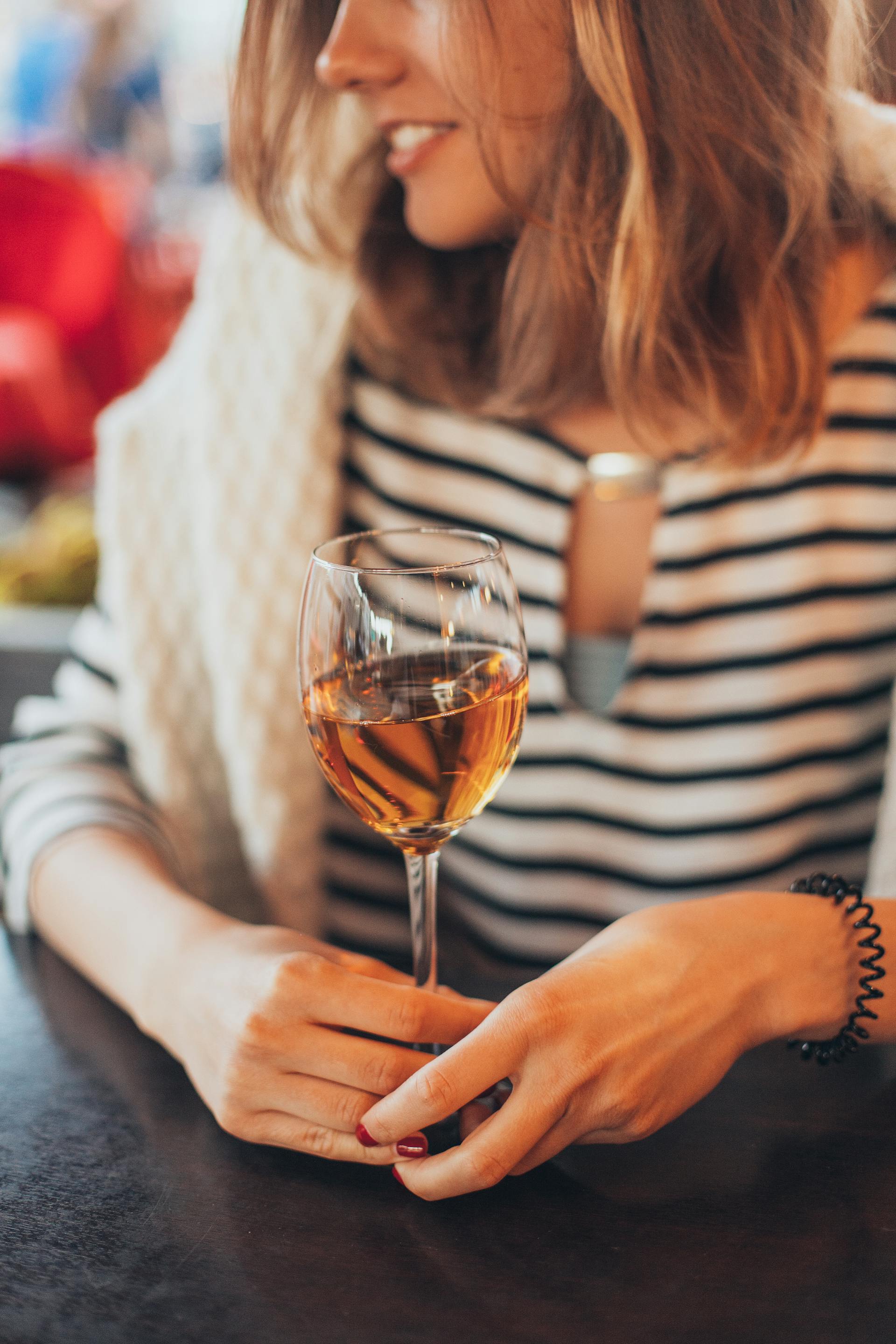 A woman holding a glass of wine | Source: Pexels