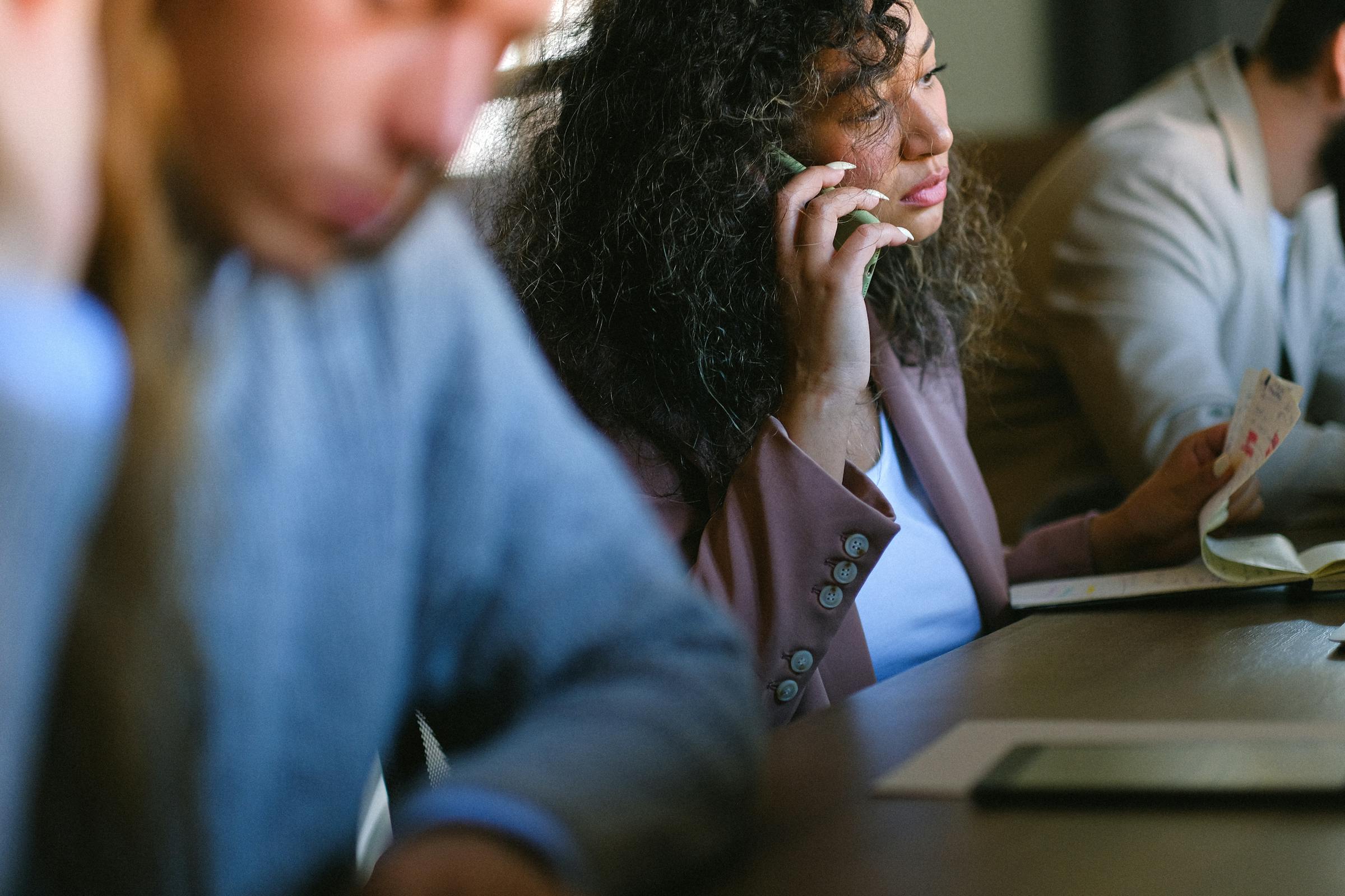 A woman at work making a call | Source: Pexels